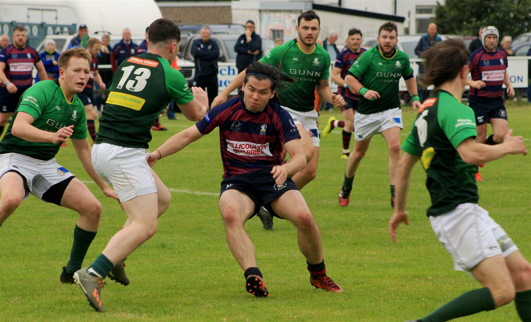 Caithness centre Charlie Quinn fending off a tackle during last season's home match against Hillfoots, who are back at Millbank this weekend. Picture: Alan Hendry