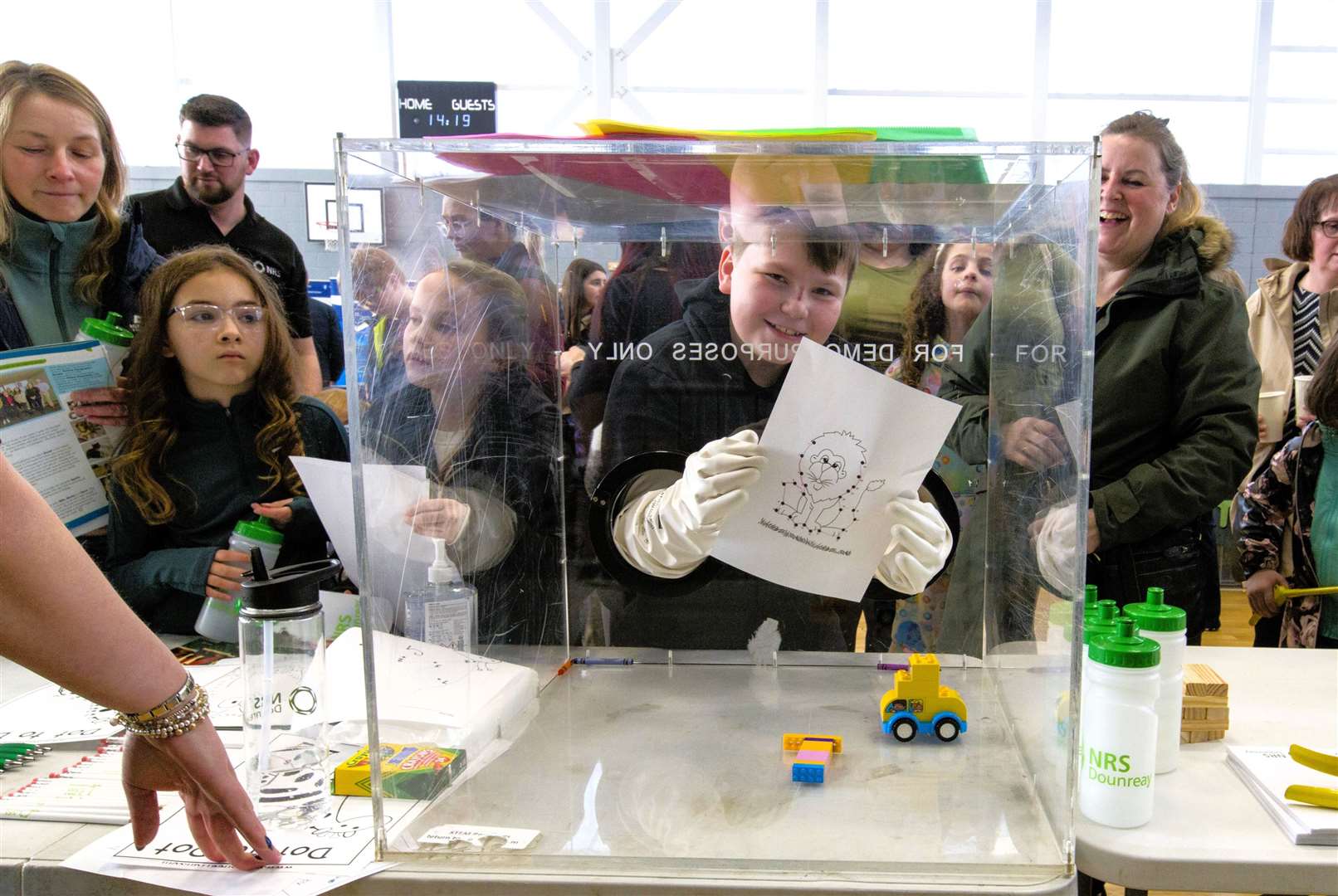 Argyll McPhee, Wick, demonstrates his dexterity when using a Dounreay 'glove box' by displaying a drawing he had done. Photo: RobertMacDonald/Northern Studios