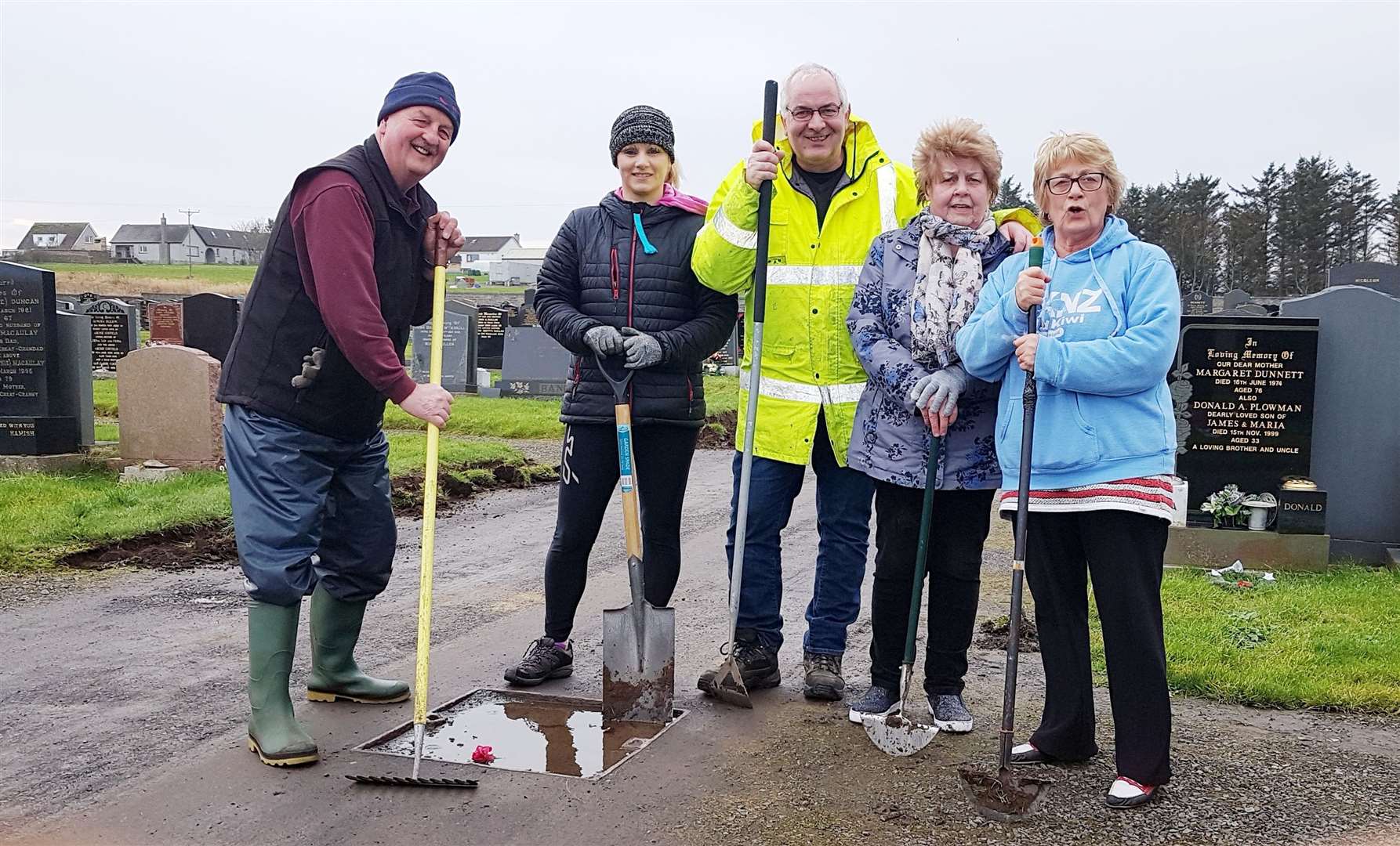 Councillor Raymond Bremner (centre) along with other volunteers helping tidy up Wick cemetery last year.
