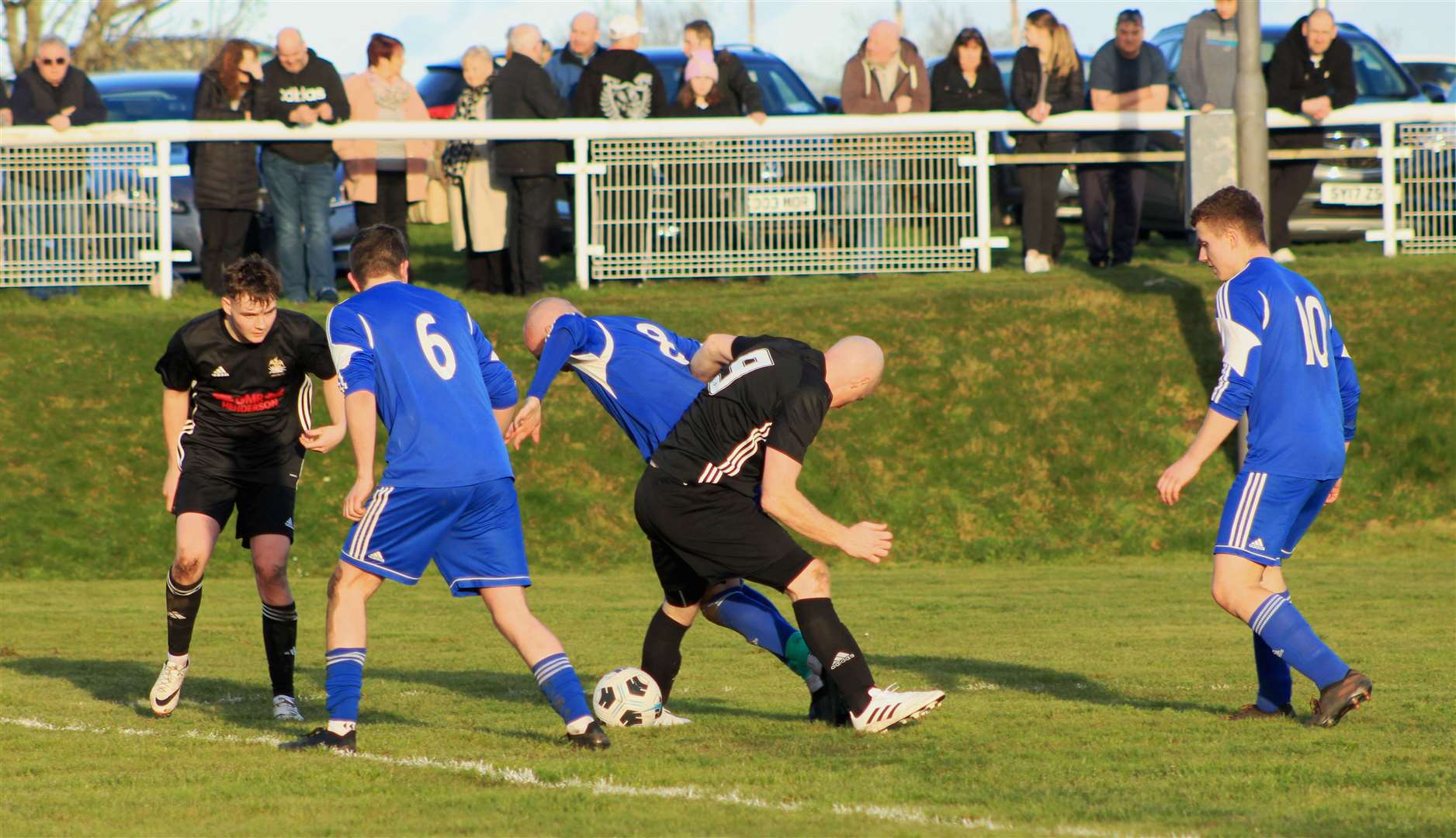 A battle for possession in the middle of the park during the Lybster v Keiss clash. Picture: Alan Hendry
