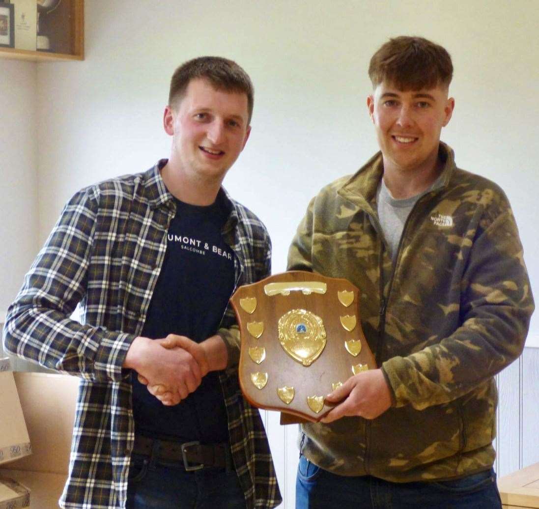 Overall champion Timothy Scott (right) receiving his shield from club chairman Jamie Morris.