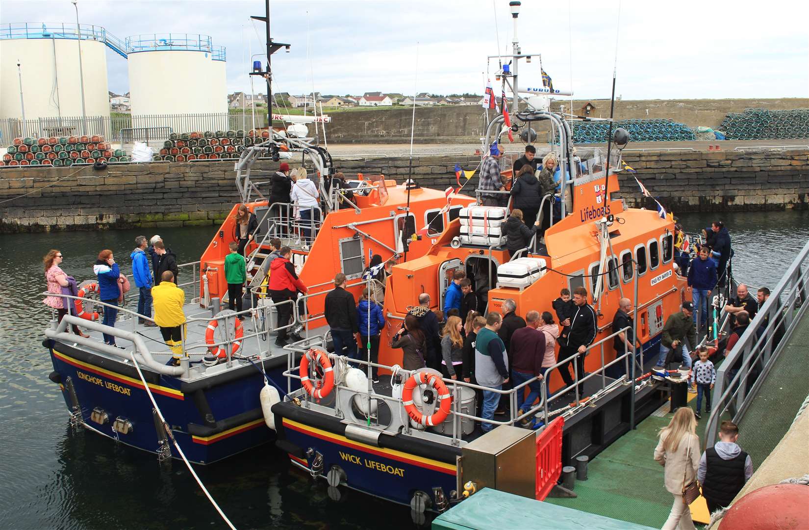 The Wick lifeboat (right) with the Longhope lifeboat alongside at the 2022 RNLI Harbour Day. Picture: Alan Hendry