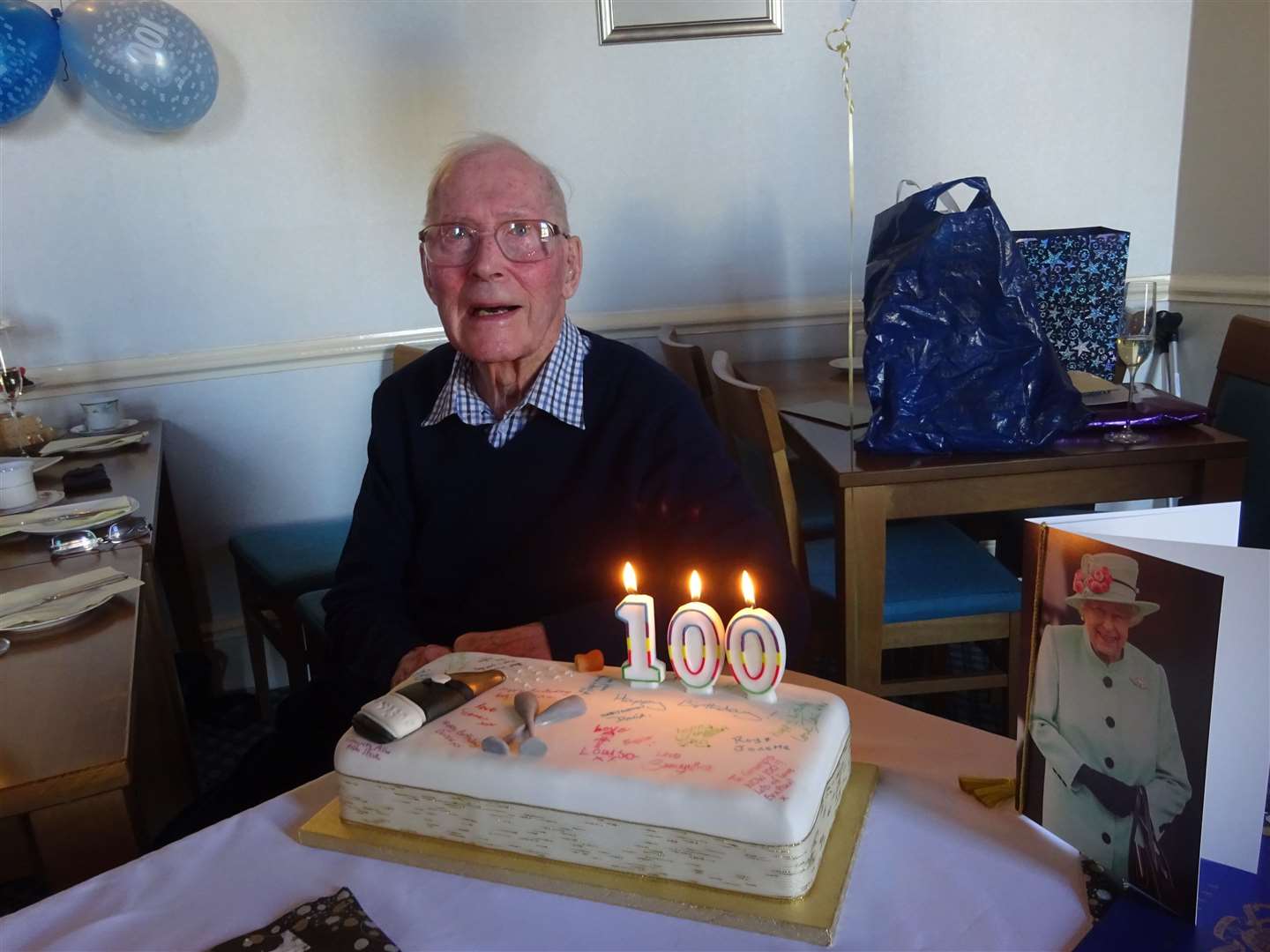 Mr Abernethy photographed with his 100th birthday cake and card from the Queen.