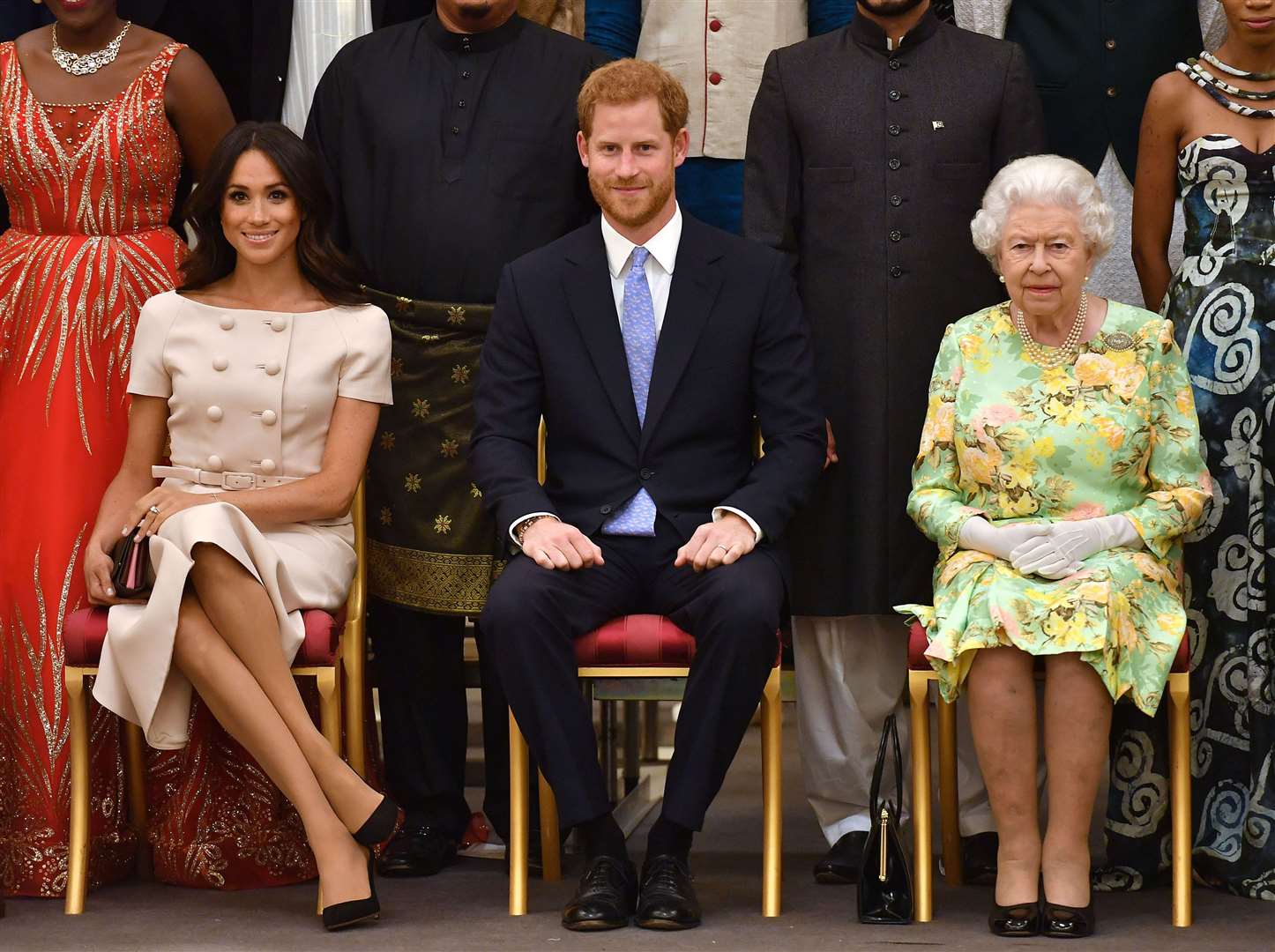 The Duke and Duchess of Sussex with Harry’s grandmother, the late Queen, during a group photo at the Queen’s Young Leaders Awards Ceremony at Buckingham Palace in 2018 (John Stillwell/PA)