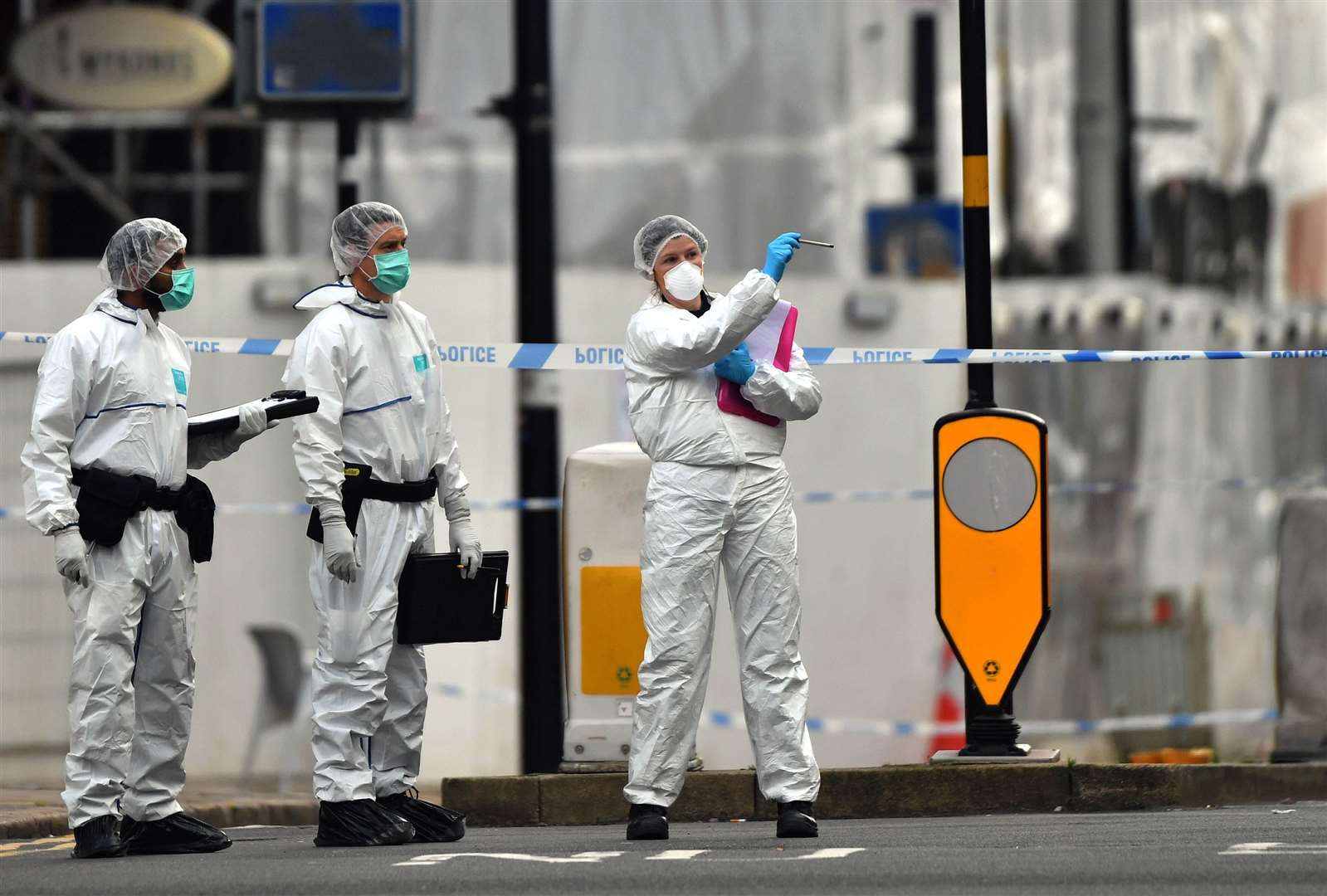 Three police forensics officers at work in Hurst Street, in Birmingham (Jacob King/PA)