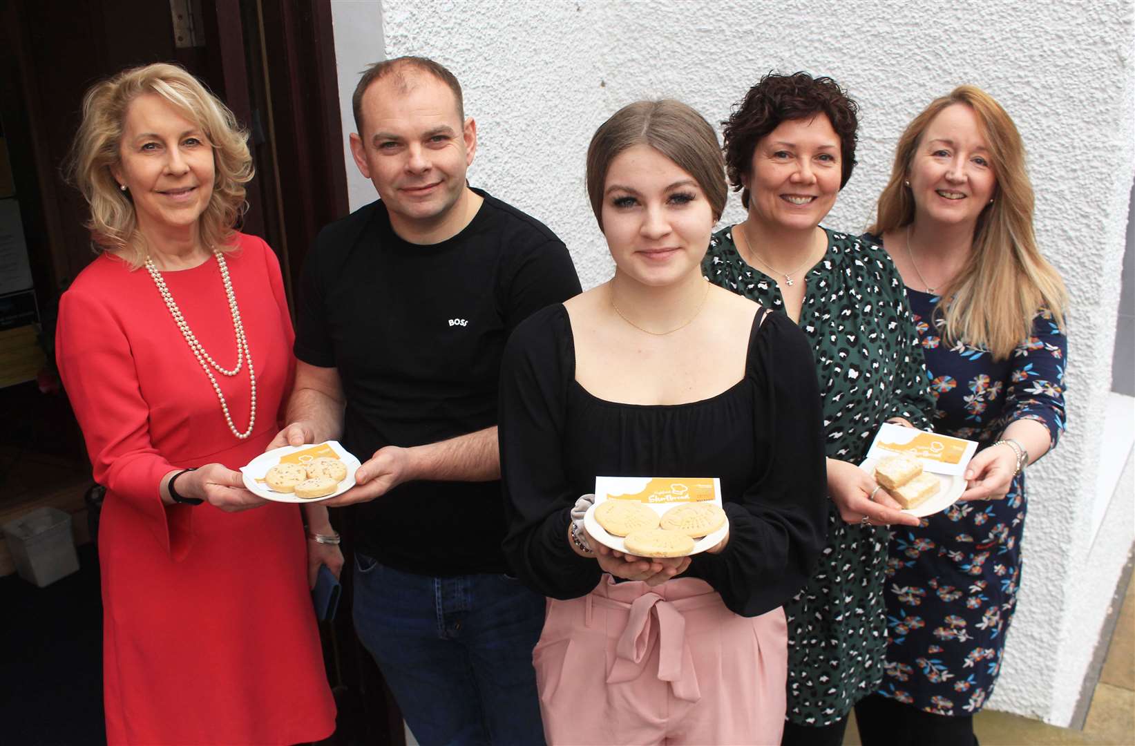 Ellie Lamont (left) and Cathy Earnshaw (right) of Venture North with Shortbread Showdown judges Gary Reid, Iona Simpson and Donna Booth outside Mackays Hotel in Wick for the Caithness and Sutherland heat. Picture: Alan Hendry