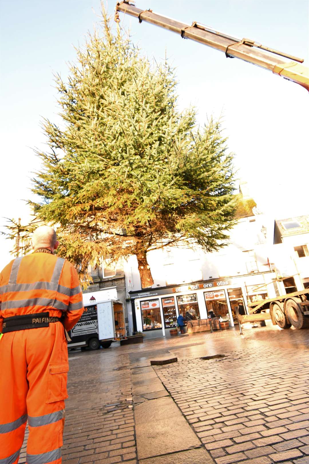 The Christmas tree is lowered into position in Wick's Market Square. Picture: Noel Donaldson