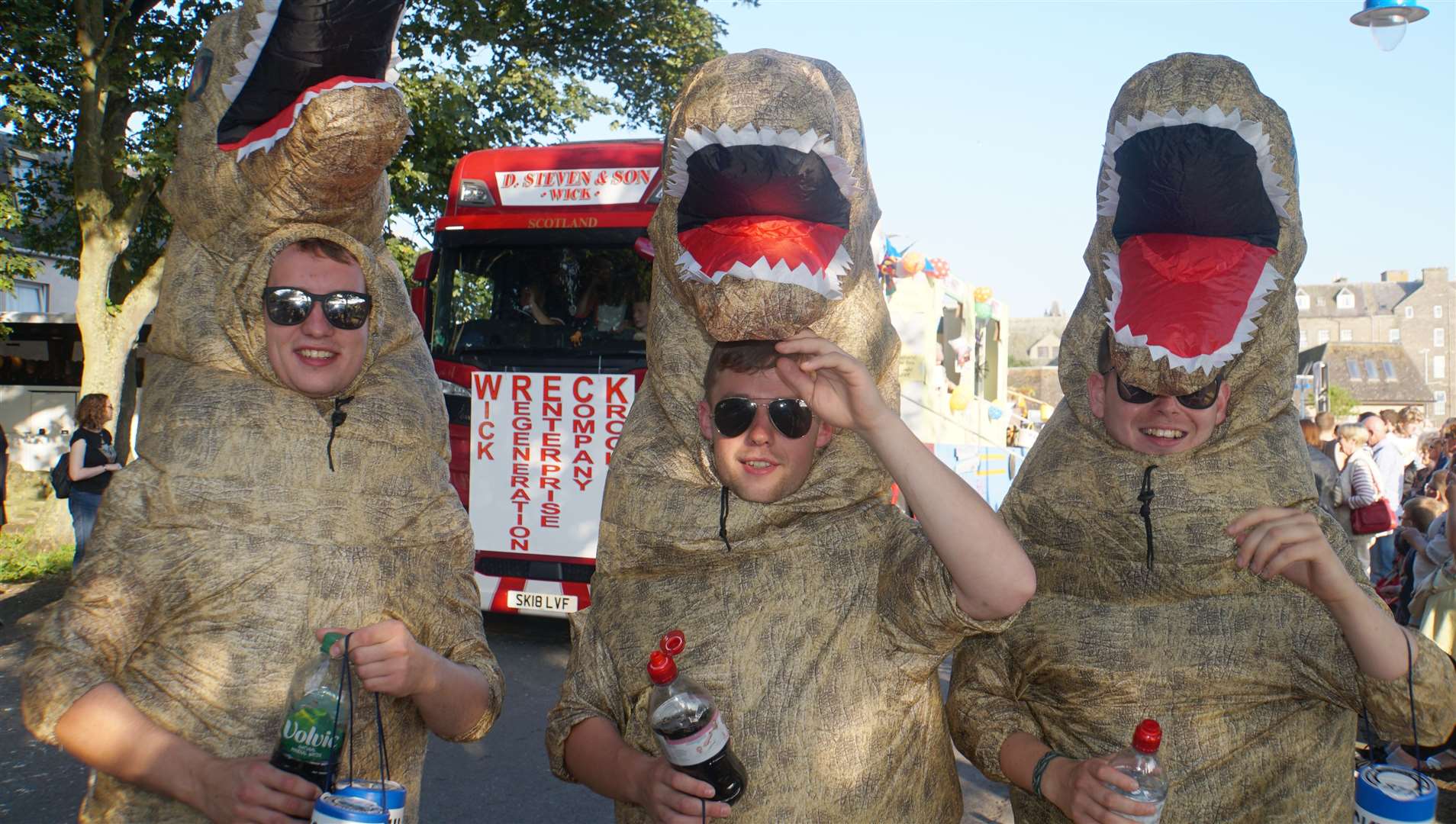 Three dinosaurs on the loose in Wick during the 2019 gala procession. Picture: DGS