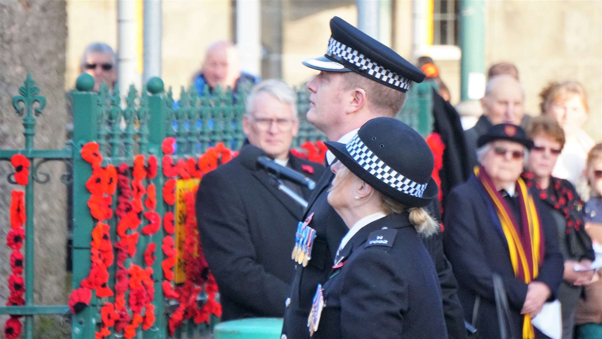 Special constable Thelma Mackenzie lays a wreath at Thurso War Memorial alongside Simon Johns, an officer from the Civil Nuclear Constabulary. Picture: DGS