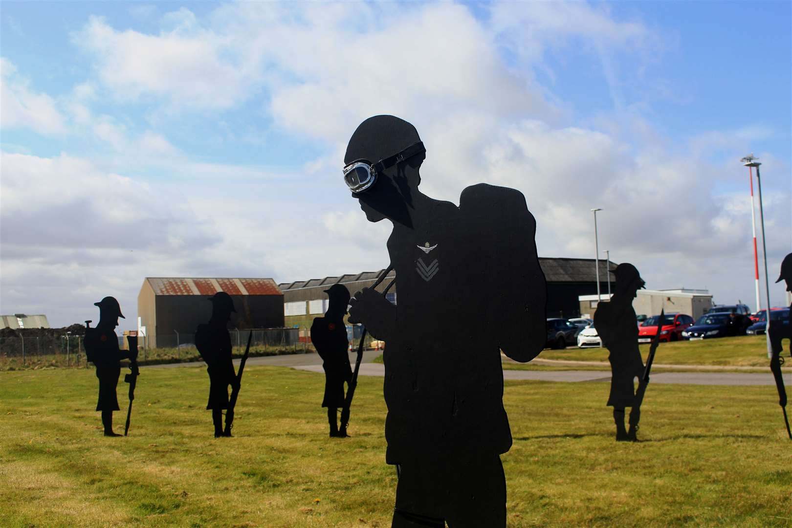 Some of the servicemen silhouettes that were positioned at the Wick airport entrance, with the World War II hangars in the background. Picture: Alan Hendry