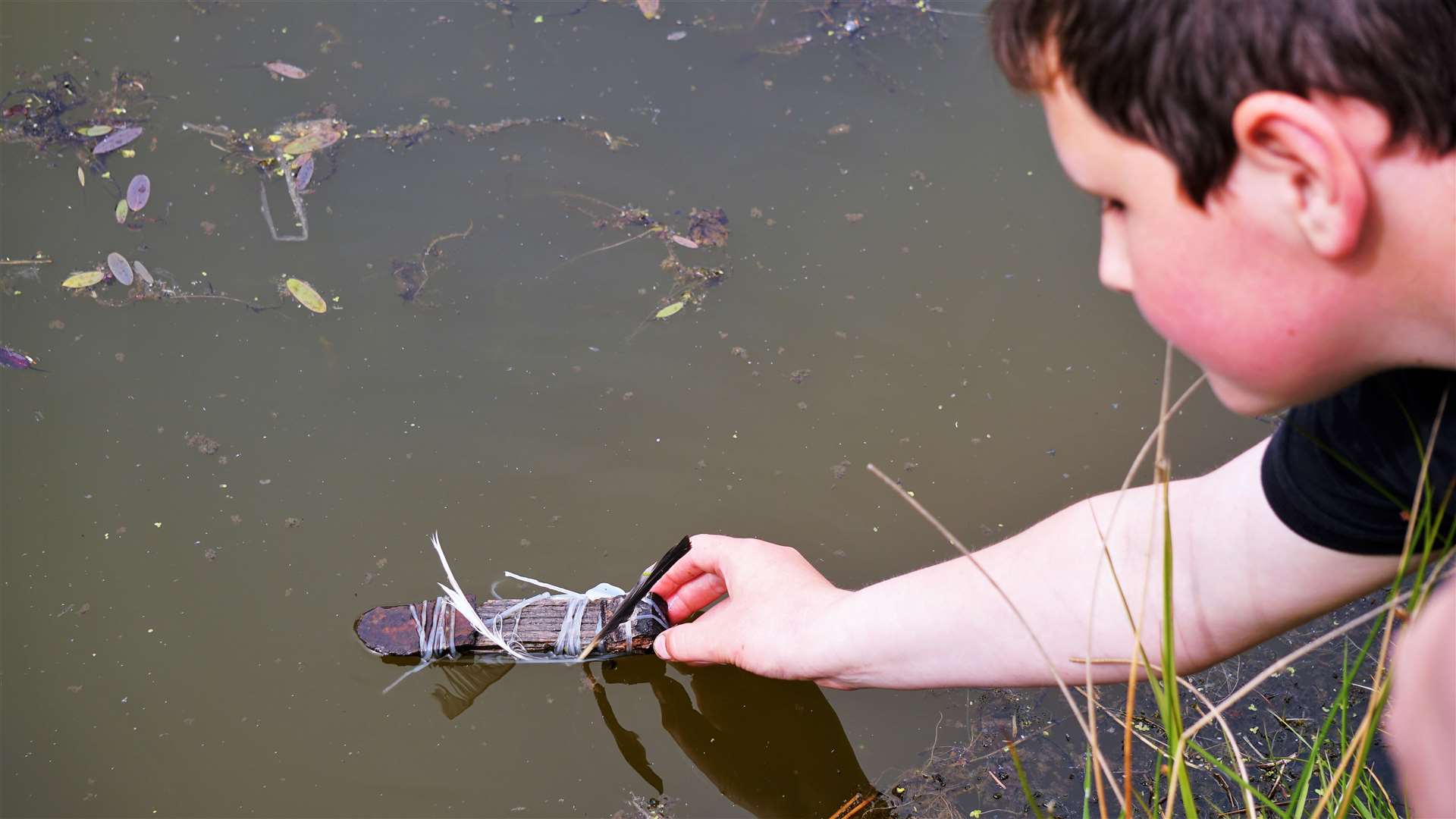 This boy made a boat out of found objects and floated it on the pond. Picture: DGS