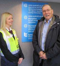A First ScotRail conductor, Lisa, advises Rob Gibson MSP on the many ways of checking if trains are running on time.