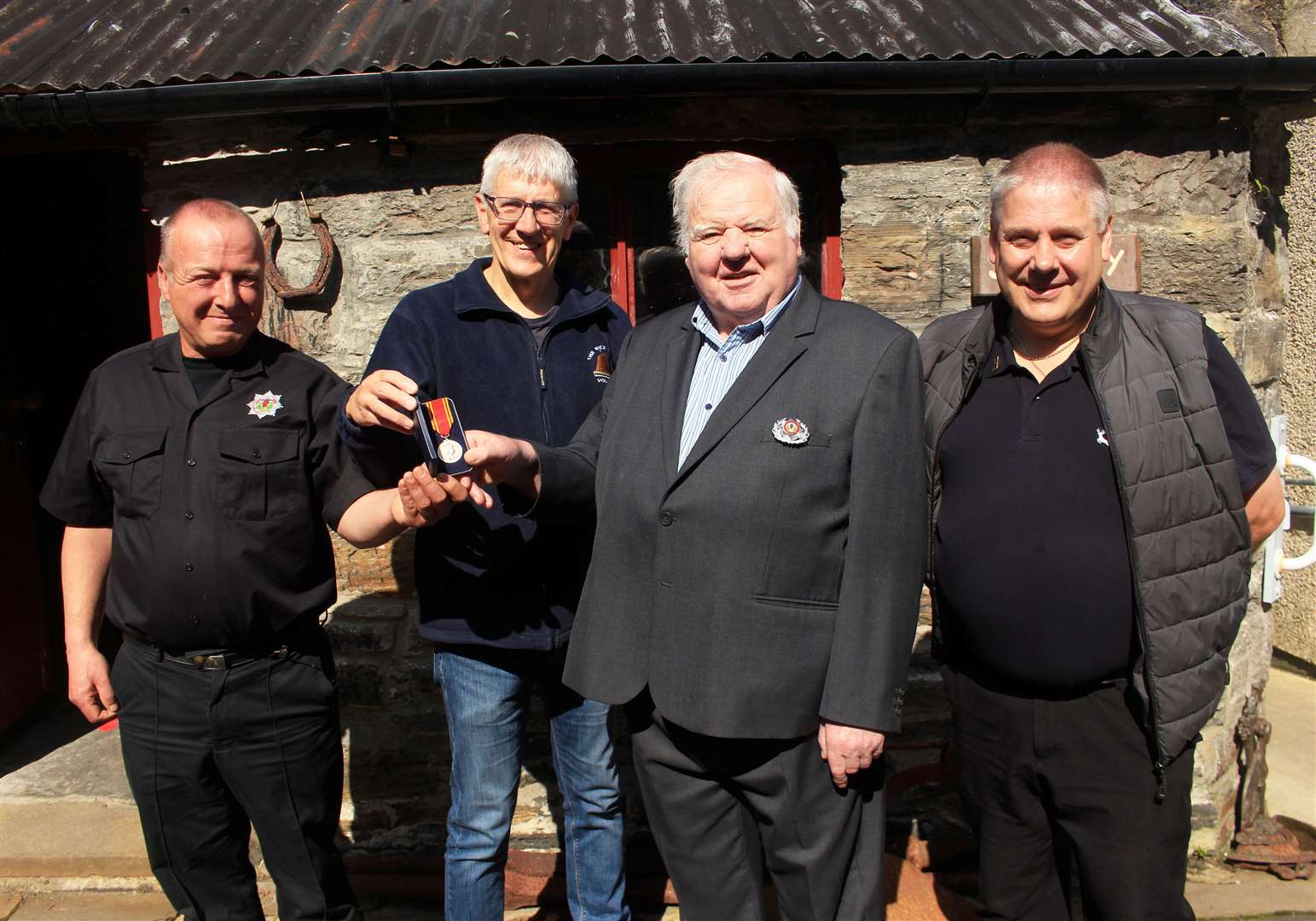 Wick Society vice-chairman Raymond Hill (second from left) receiving Jimmy Dunne’s medal from David Anderson (left), Bruce Simpson and Mervyn Hill (right). Picture: Alan Hendry