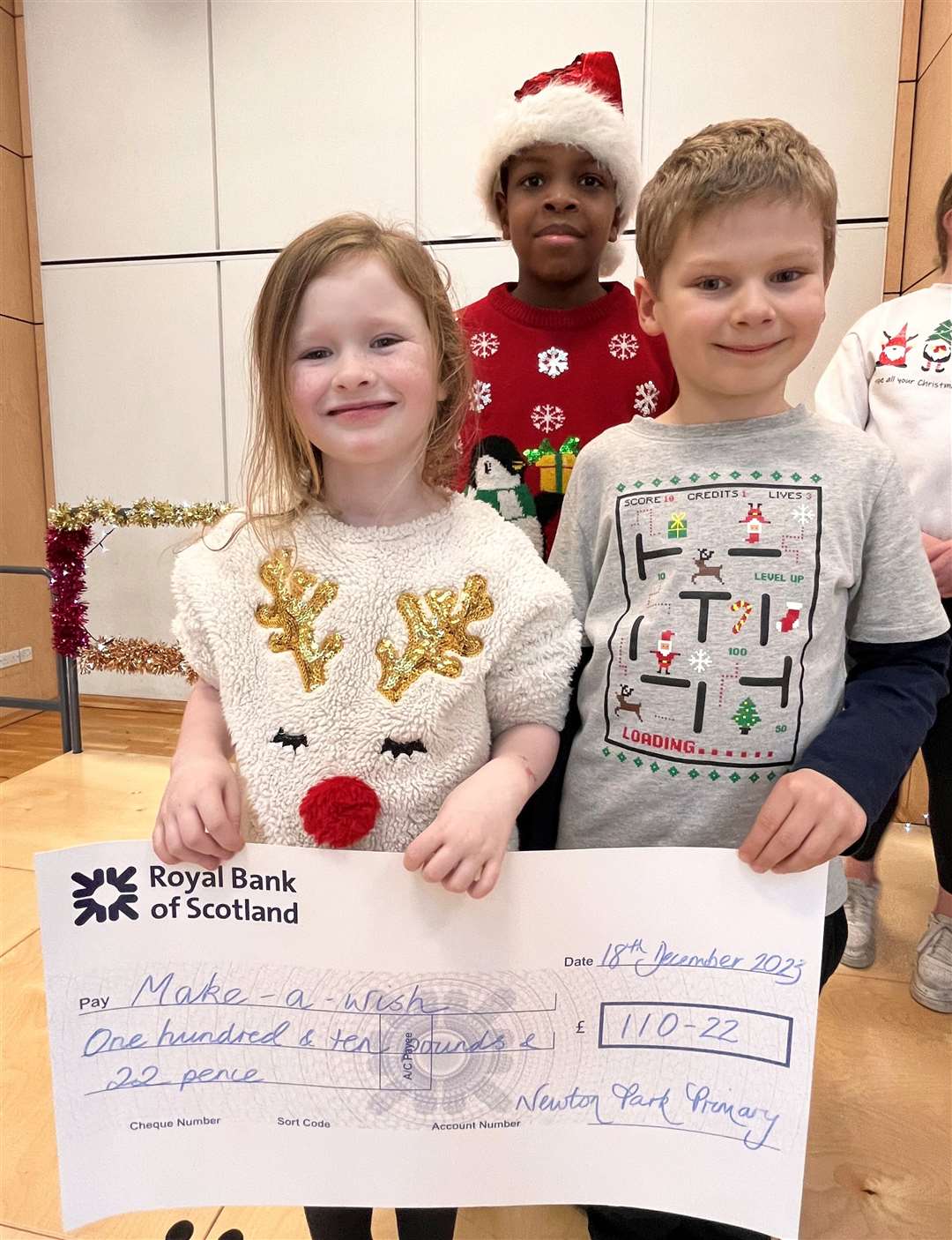 Pupils at Newton Park holding the Make-A-Wish cheque.