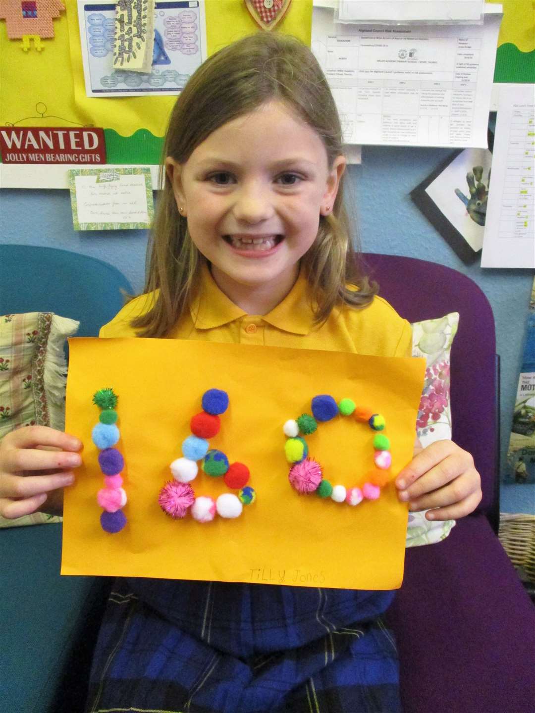 This little girl used pom poms to create the number 160.