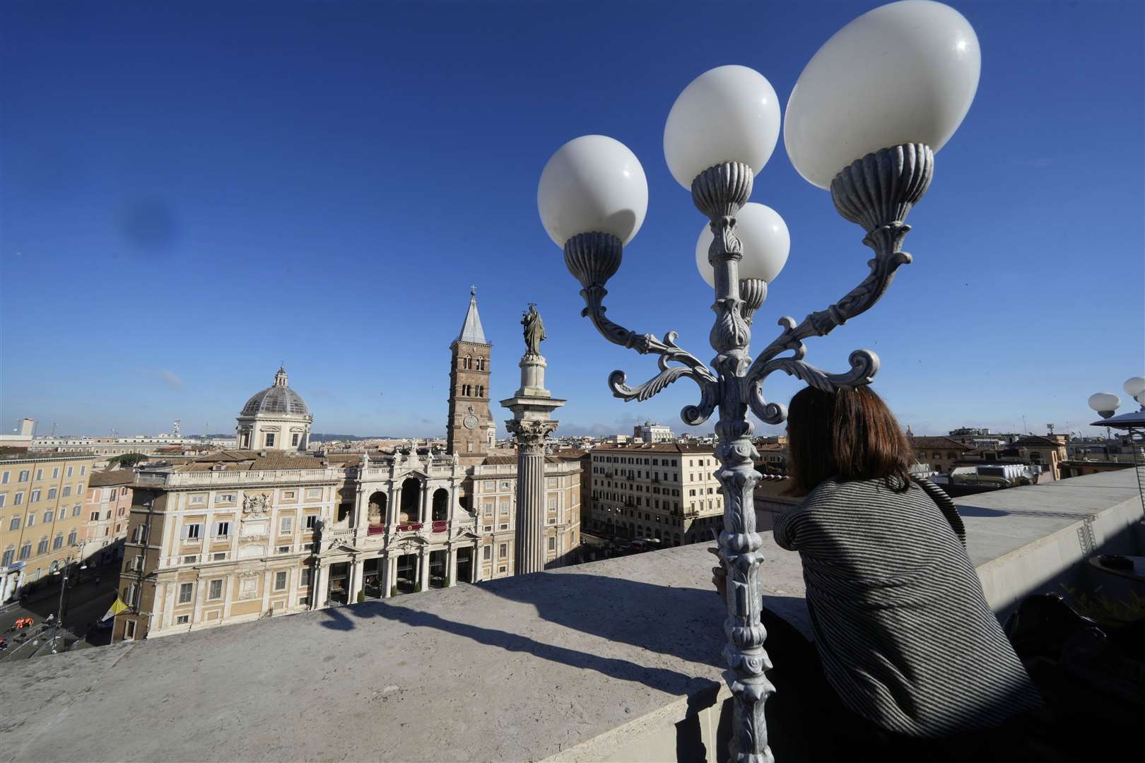 A woman looks at St Mary Major Basilica, where the burial ceremony of Pope Francis will take place, in Rome (Luca Bruno/AP)