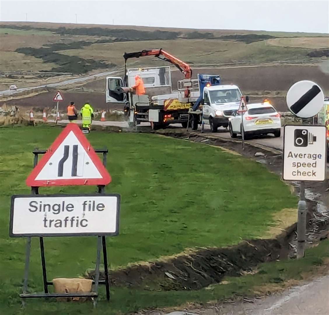 Workers removing part of the speed camera system from near the business park alongside the A836 on Monday. Picture: Alison Reiss