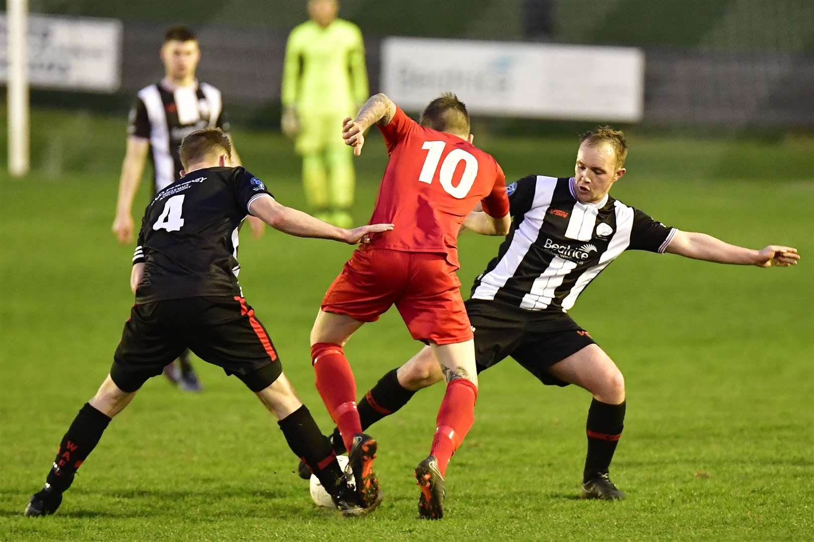 Alan Farquhar and Richard Macadie combine to stop Brora's Kyle Macleod. Picture: Mel Roger