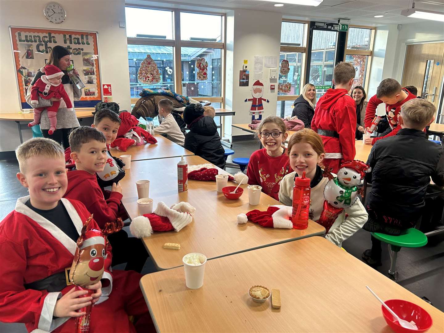 Some of the Noss pupils enjoying hot chocolate, mince pies and shortbread after the Santa dash.