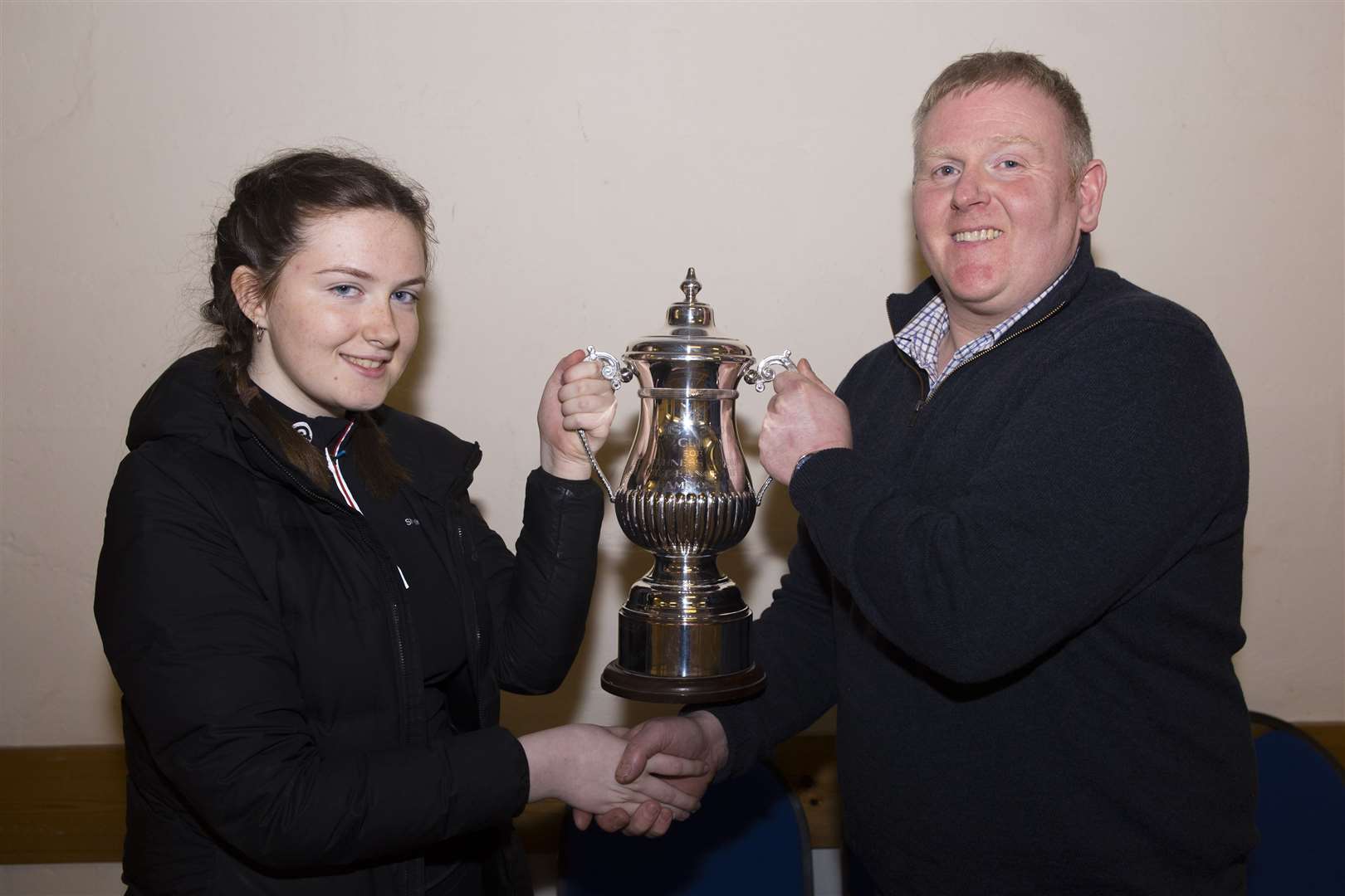 Sophie Campbell receiving the Daisy 2000 indoor championship trophy from Graham Mackay, chairman of Caithness Small Bore Rifle Association. Picture: Robert MacDonald / Northern Studios