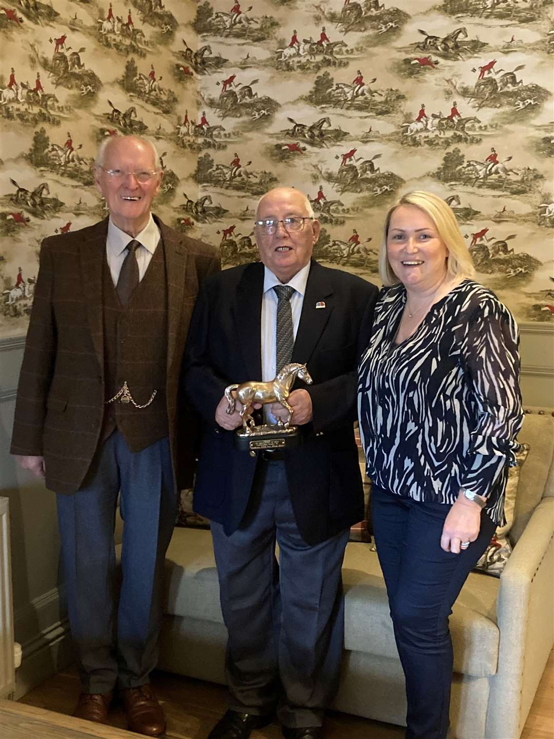 Christie Cameron (centre) received his award in recognition of many years' service to Caithness RDA from Jimmy Johnson, trustee, while group chairperson Judith Miller looked on.