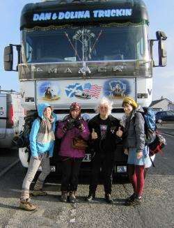 Ria Ashcroft, Hannah Stone and Kristy Guest at John O’Groats with local trucker Dan Mackenzie and his massive Renault Magnum.