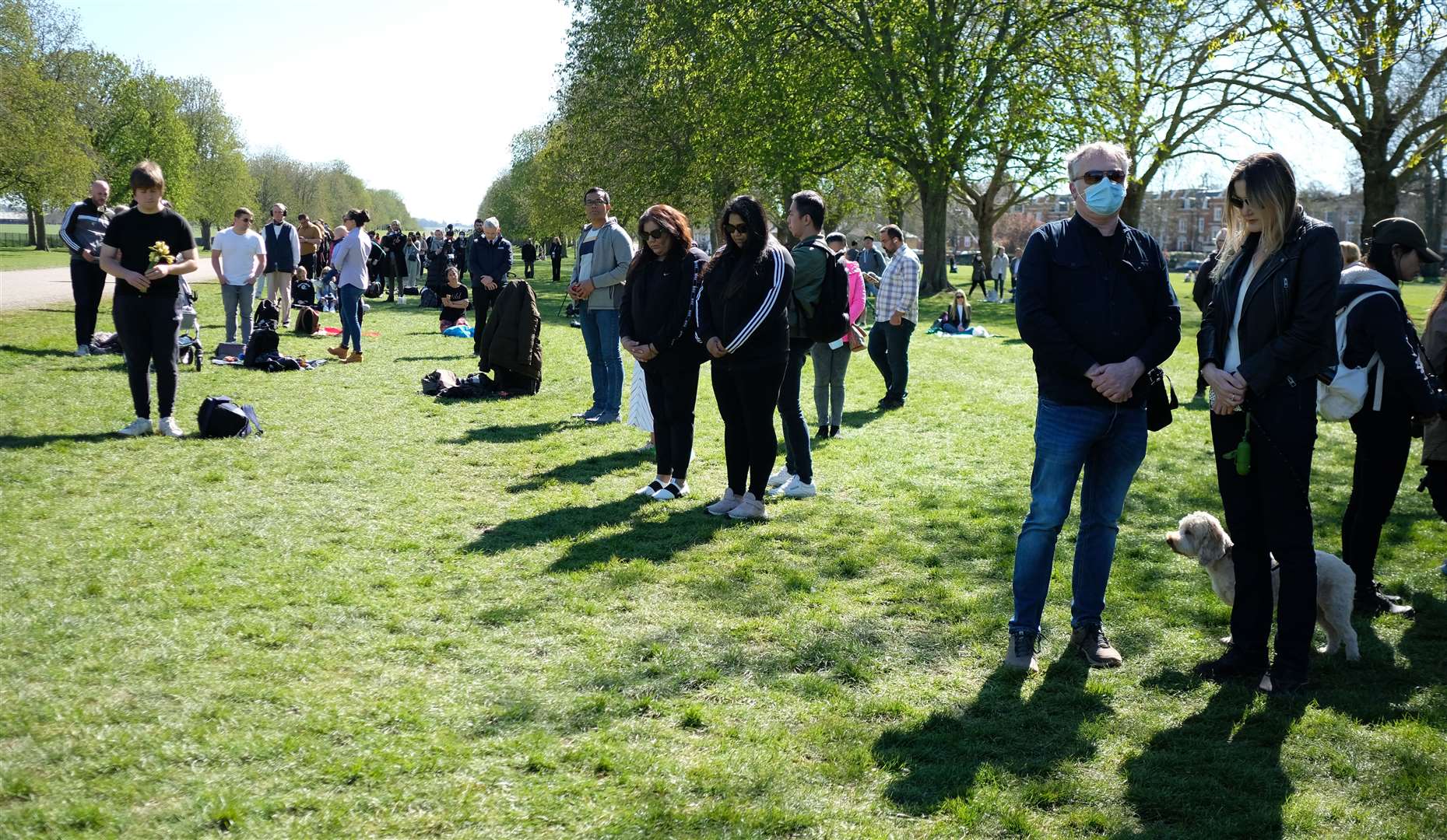 People observe a minute’s silence on the Long Walk outside Windsor Castle (Andrew Matthews/PA)