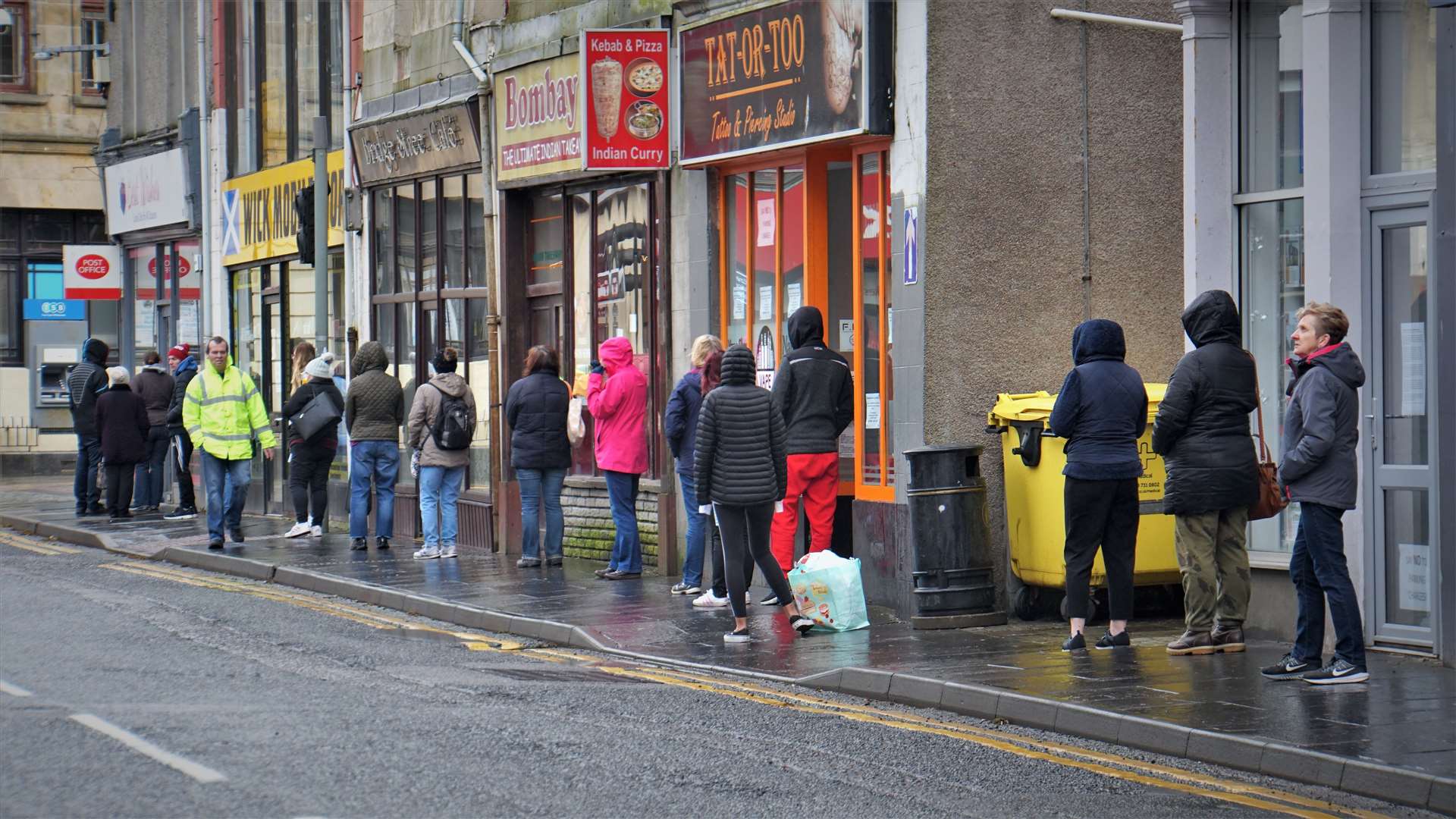 Customers wait to get in to the post office in Wick's Bridge Street on Wednesday morning. Picture: DGS