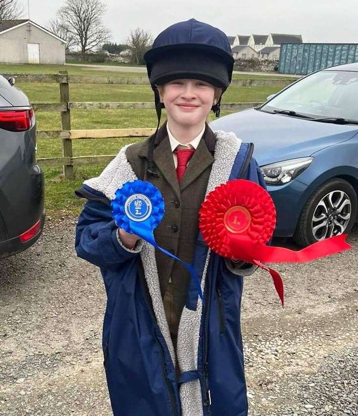 Caysie Sinclair proudly displays her rosettes from the day.