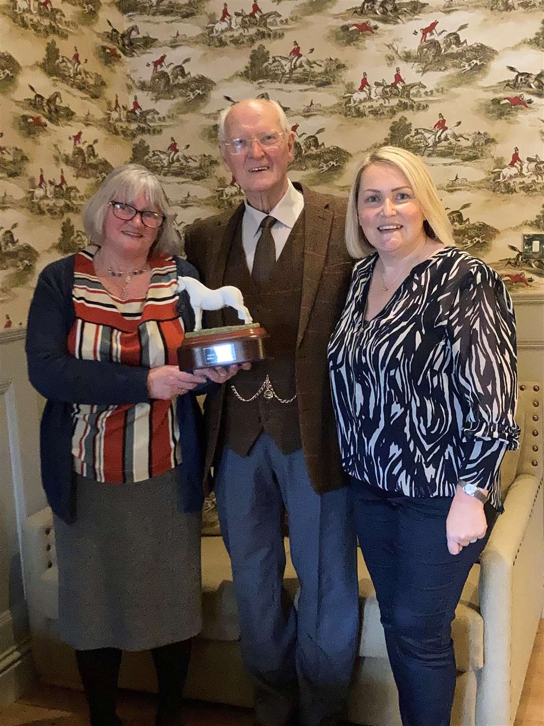 Volunteer Irene Morris (left) received the Bambi award for being a dedicated helper from Jimmy Johnston one of the group's trustees along with chairperson Judith Miller on the right.