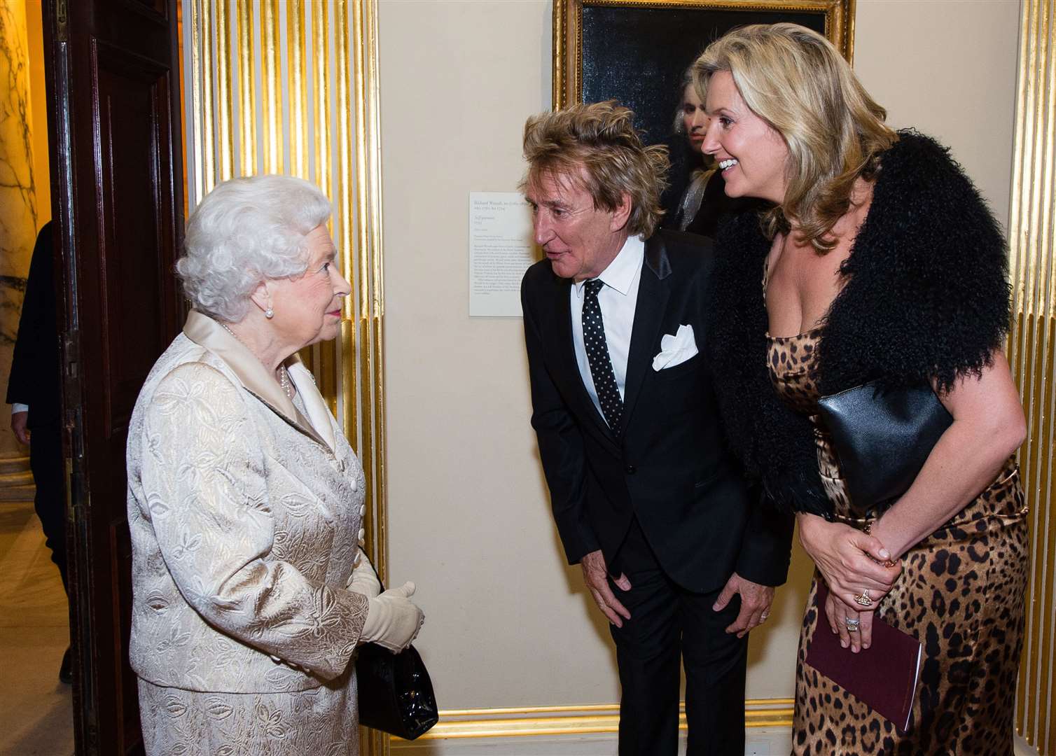 The Queen meets Sir Rod Stewart and his wife Penny Lancaster during a reception and awards ceremony at the Royal Academy of Arts, Burlington House, London (Jeff Spicer/PA)