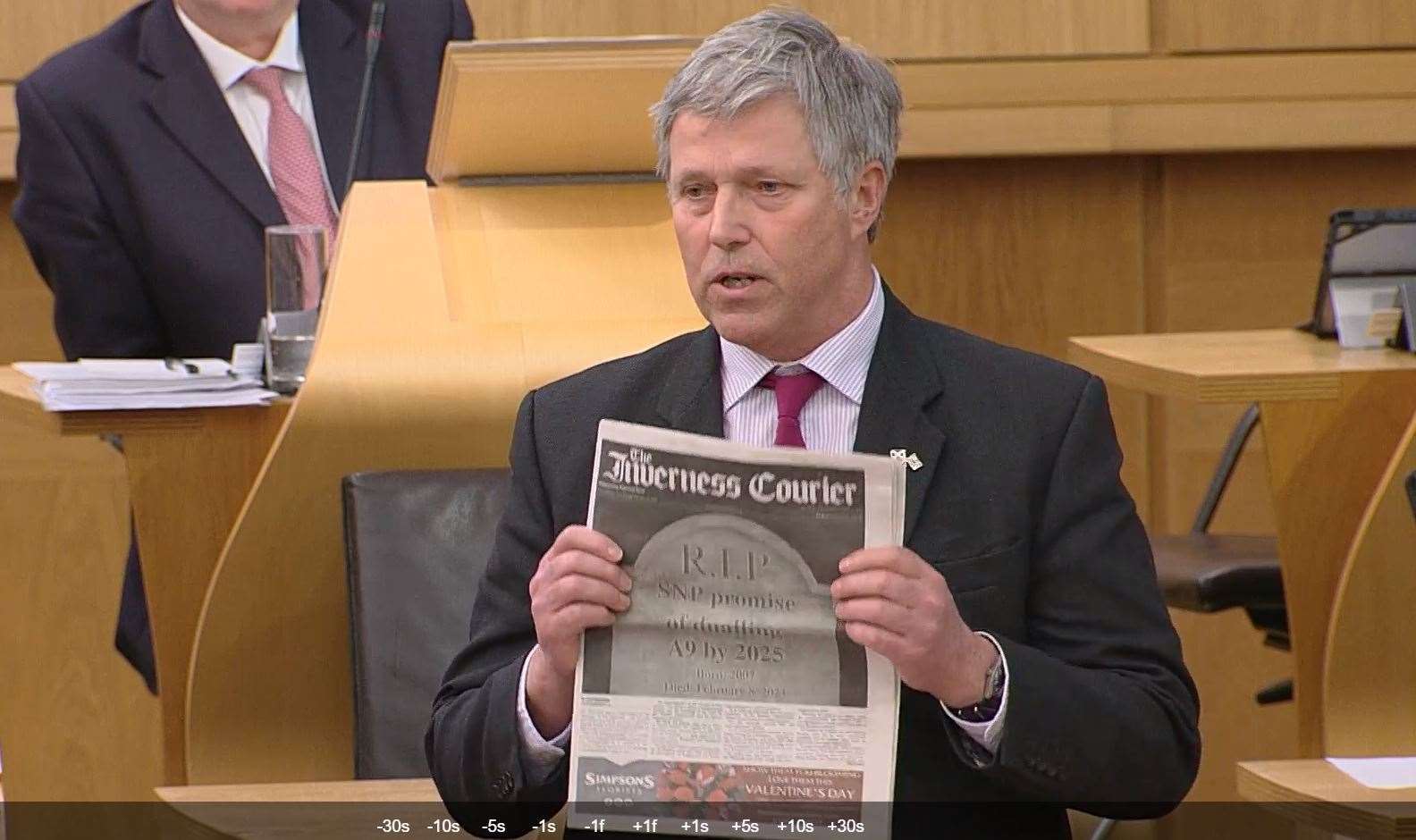 The Inverness Courier frontpage being shown in parliament by MSP Edward Mountain