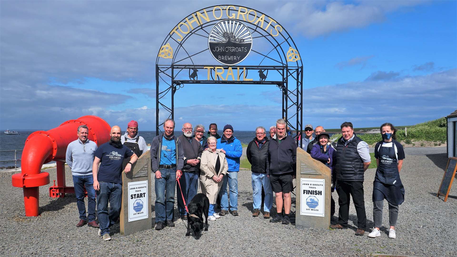 The various funders and supporters gather at the John O'Groats gateway arch to announce it officially open on Monday afternoon. Pictures: DGS