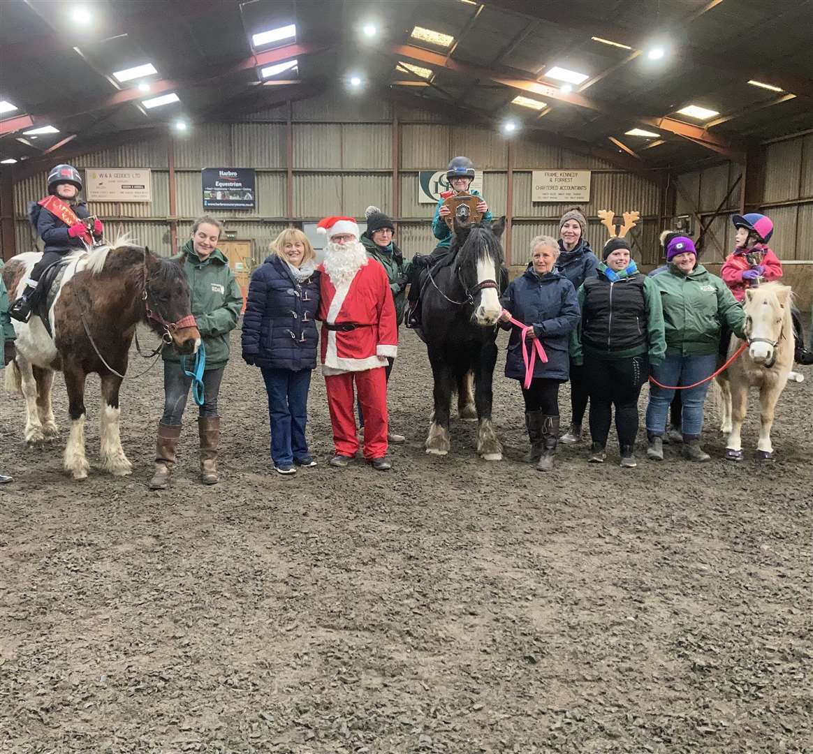 Ride 2 from Noss Primary School line-up to meet Santa along with some of the RDA volunteers.
