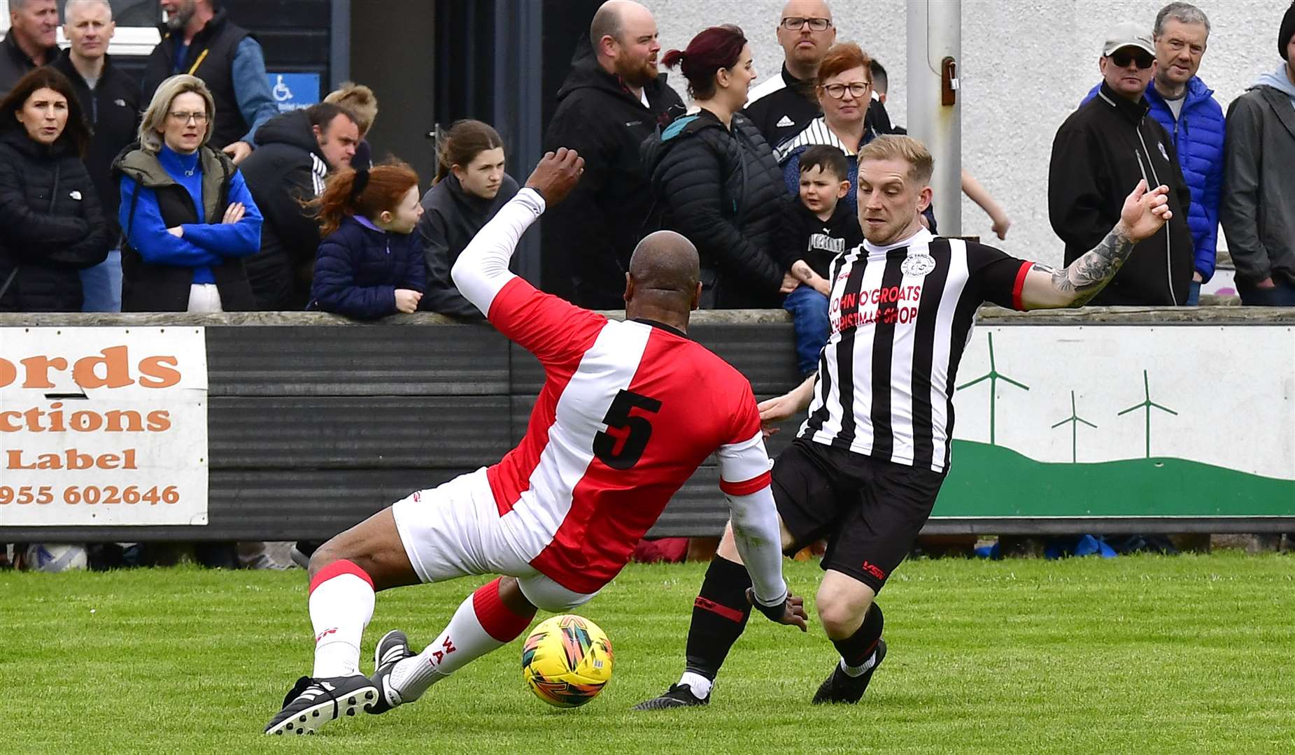 Marvin Andrews (SPL Legends) puts in a challenge on Wick Academy's Alan Hughes. Picture: Mel Roger