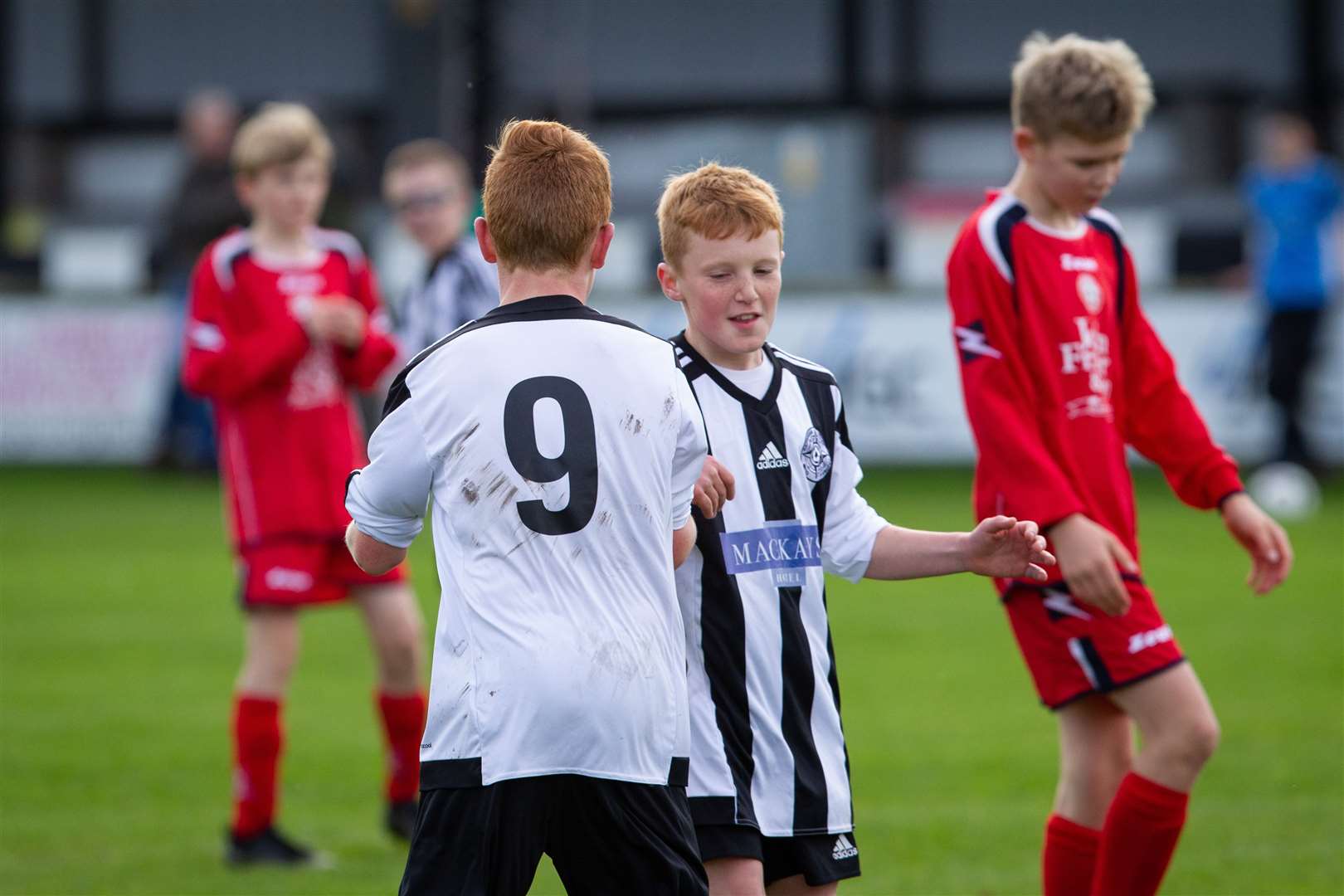 Number 9 Morgan Kennedy congratulates Jayden Bremner on his first Caithness United goal. Picture: Gareth Watkins