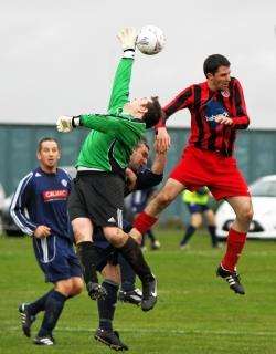 Muir of Ord goalkeeper Lee Wainwright manages to stretch for a cross ball to prevent Halkirk’s Colin Davidson from scoring during Saturday’s cup clash. Photo: www.jamesgunn.co.uk