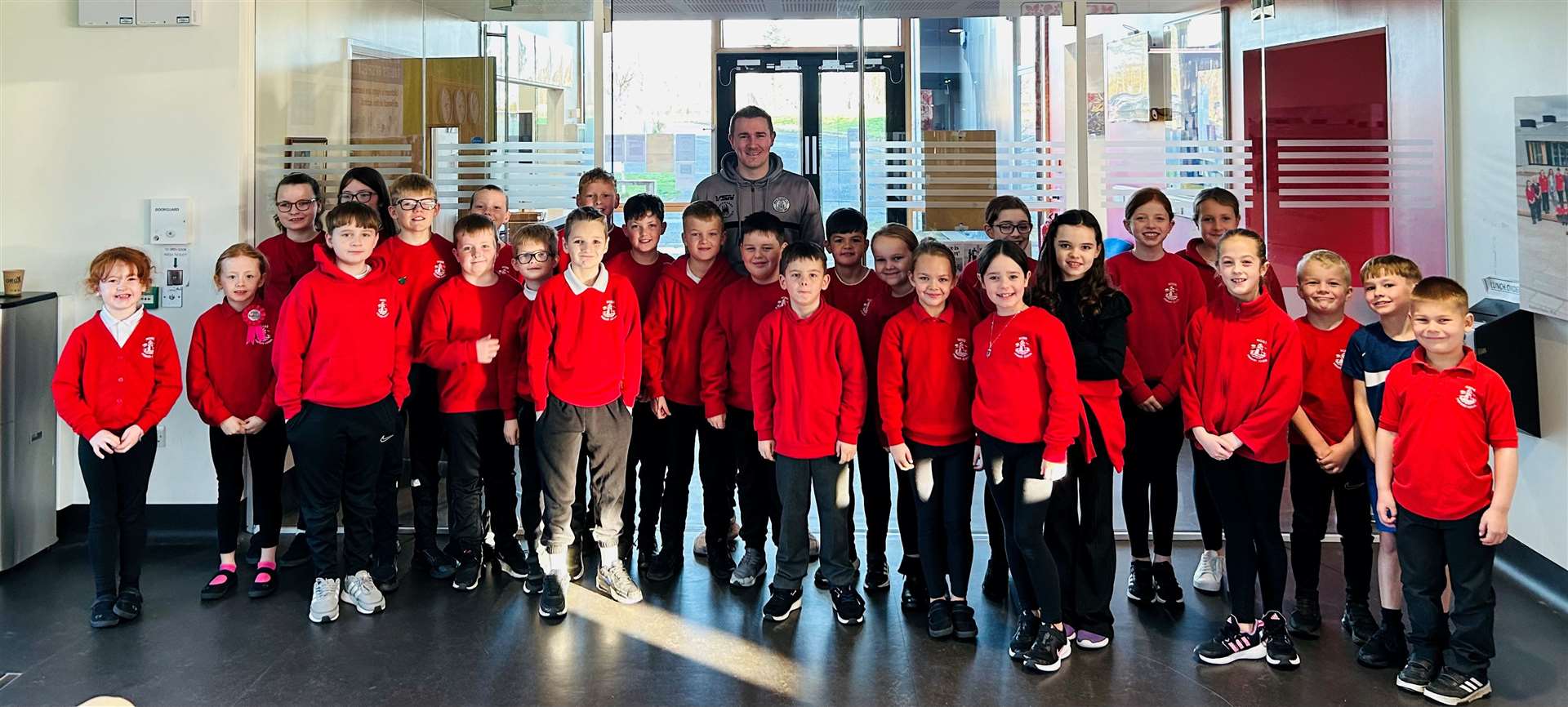 Wick Academy manager Gary Manson with pupils at Noss Primary School.