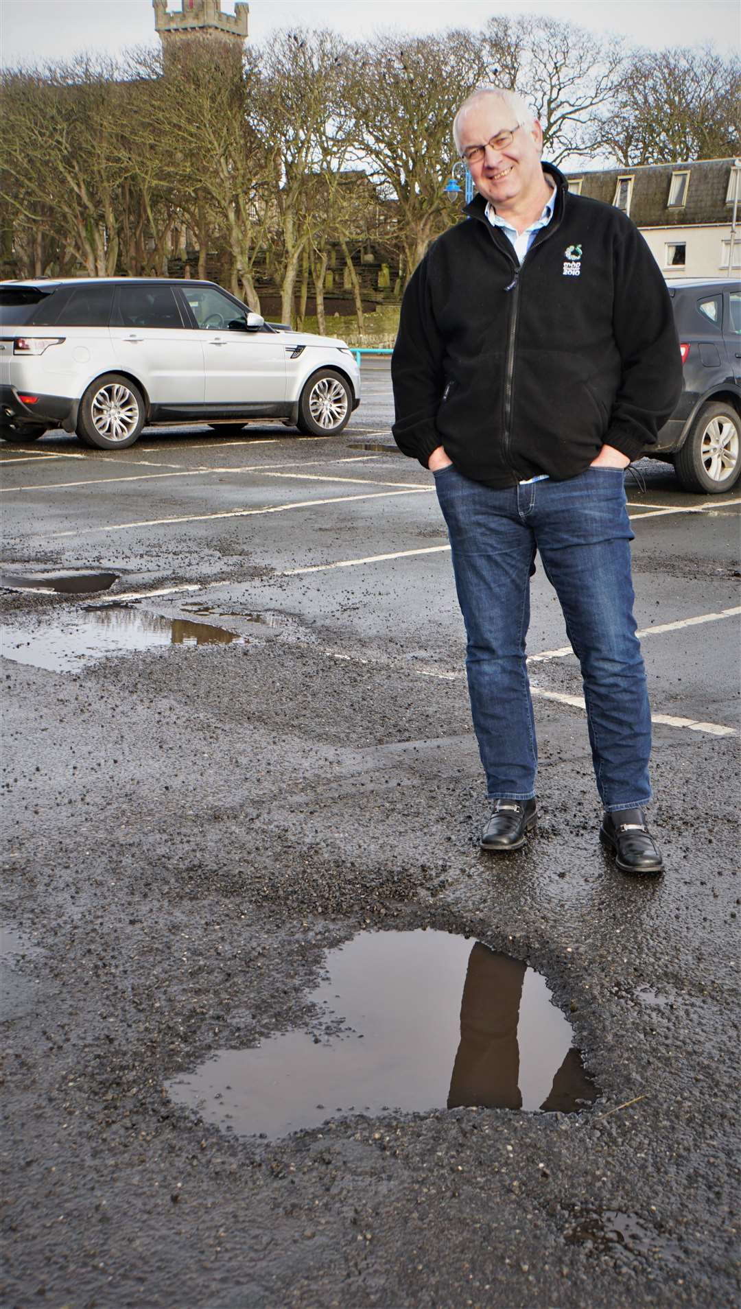 Councillor Raymond Bremner pictured in 2019 beside a heart-shaped pothole in Wick riverside car park that has since been fixed. Picture: DGS