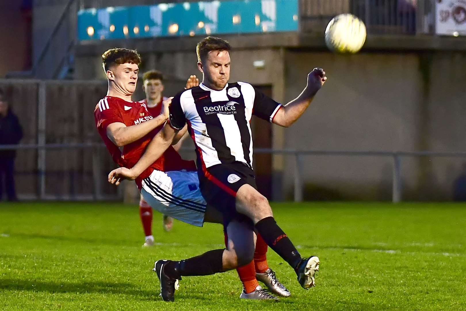 Alan Farquhar clears the ball ahead of Deveronvale's Ryan Park. Picture: Mel Roger