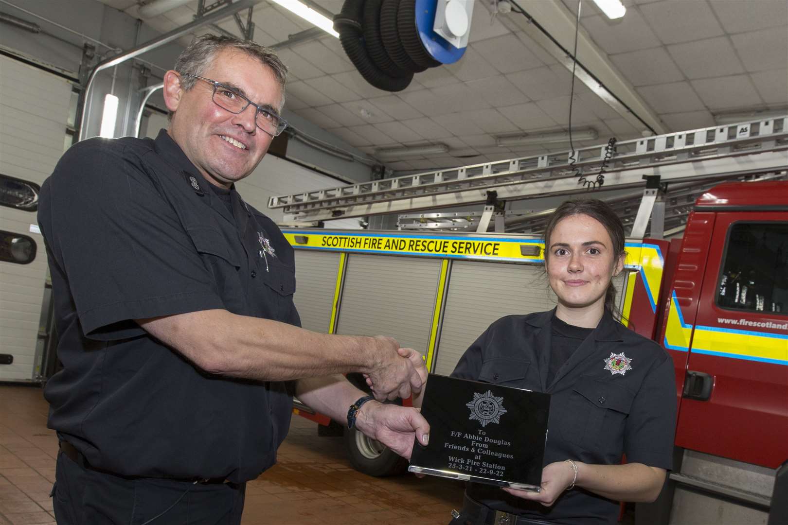Abbie Douglas receives an engraved plaque marking her 18 months’ service from watch officer Colin Gunn. Picture: Robert MacDonald/Northern Studios