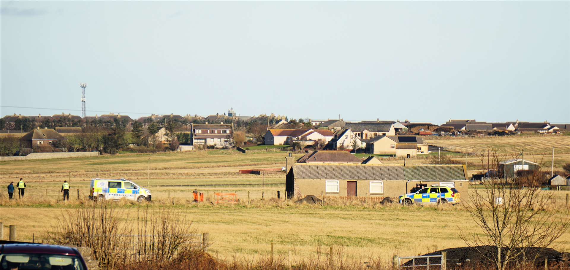 Various police vehicles on the side road leading to the Barns of Hempriggs farm. Picture: DGS