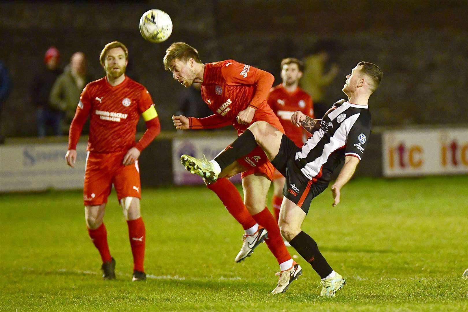 Brora's Martin Maclean heads the ball clear from Wick Academy's Gordon MacNab. Picture: Mel Roger