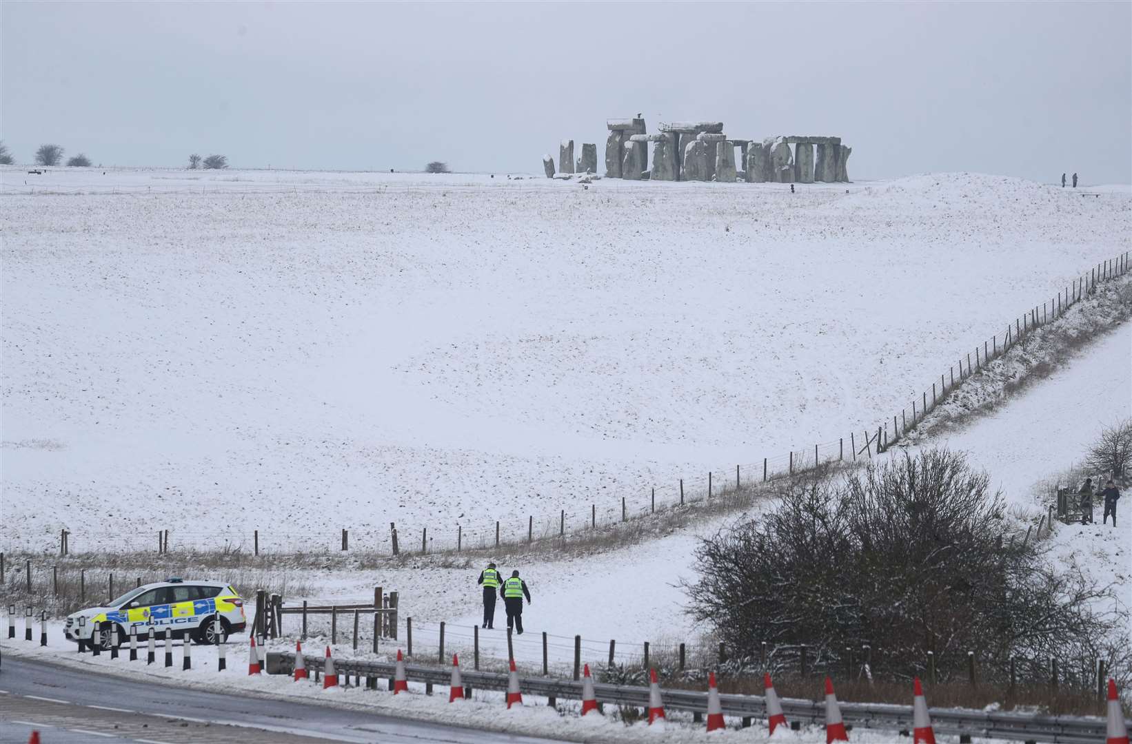 Police at a snowy Stonehenge in Wiltshire (Andrew Matthews/PA)
