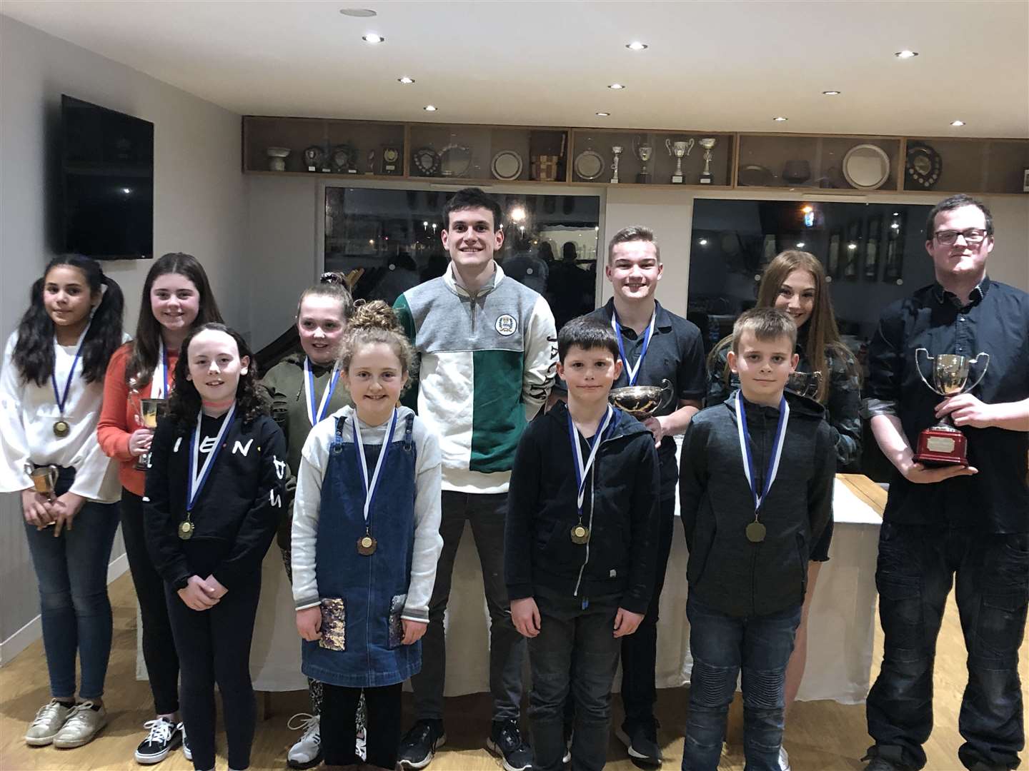 Trophy winners at CAAC's annual prize-giving, with junior coaches Kieran Johns, Erin MacIntosh and Ryan McCarthy looking on.