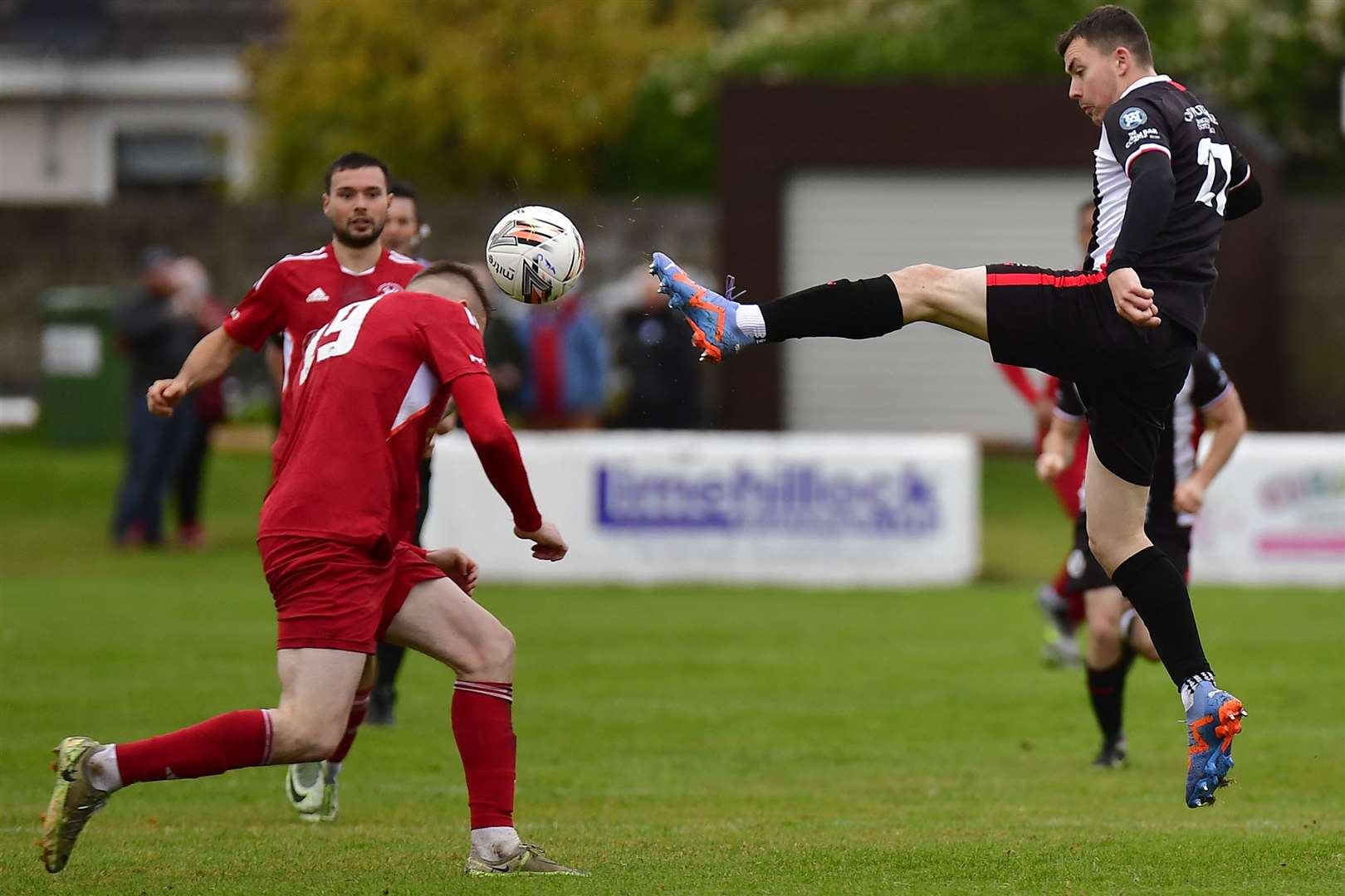 Ryan Campbell of Wick Academy stretches for the ball ahead of James Leslie in the Scorries' last outing, a 1-0 defeat at Lossiemouth. Picture: Mel Roger