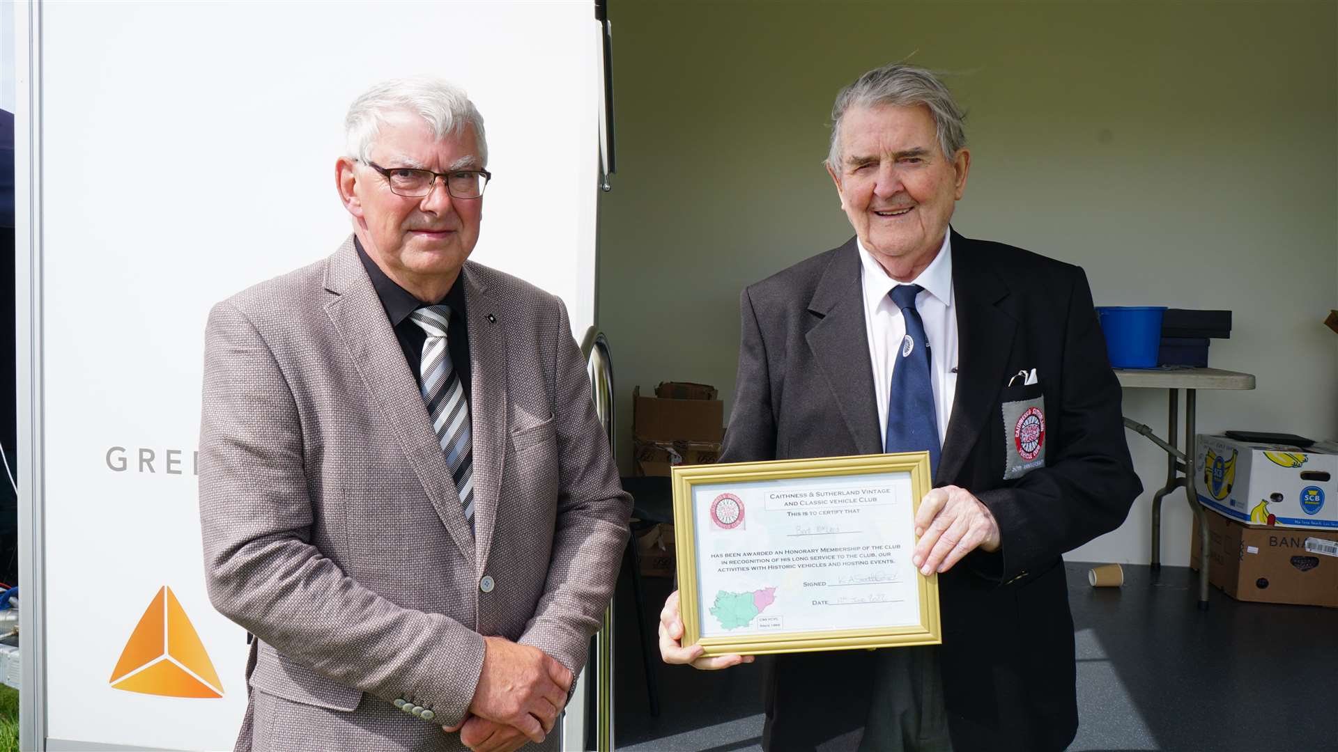 Iain Sutherland, left, gives an honorary award to Bert Macleod from Thurso, ex club chairman. Picture: DGS