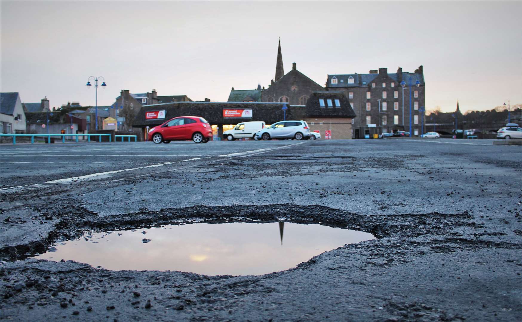 People using Wick's riverside car park will soon be saying goodbye to potholes in the area. This one was photographed before temporary repairs were carried out in May. Picture: Alan Hendry