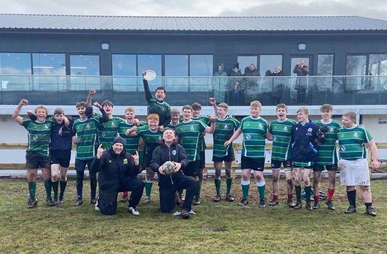 The victorious Caithness boys' U16s with coaches Donald Buchanan (left) and Ewen Boyd after lifting the Saltire Energy Quaich.