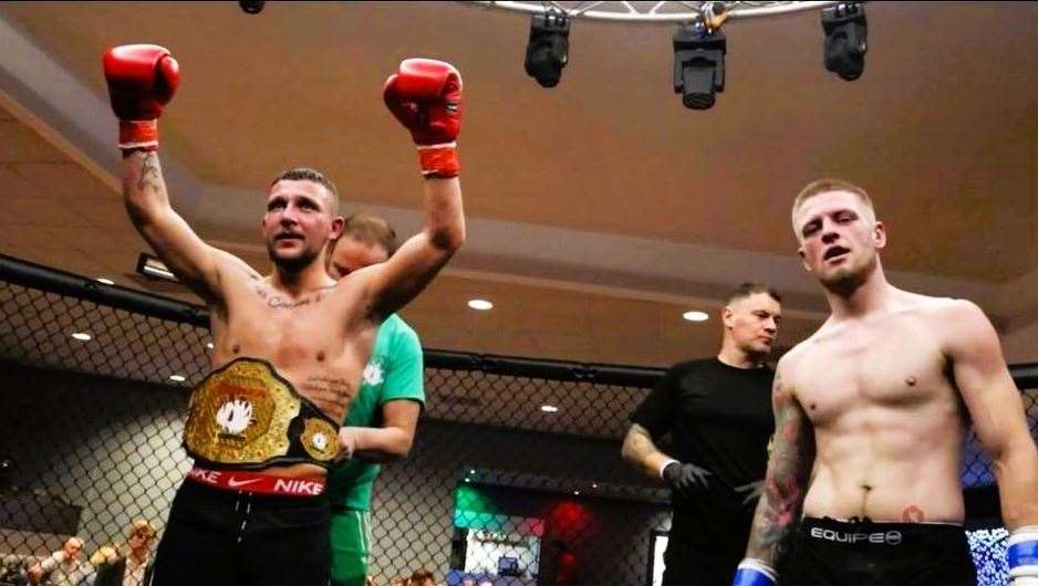 Luke McDowall beat Josh Anderson at the cage boxing match in Dalkeith and receives the featherweight champion's belt.